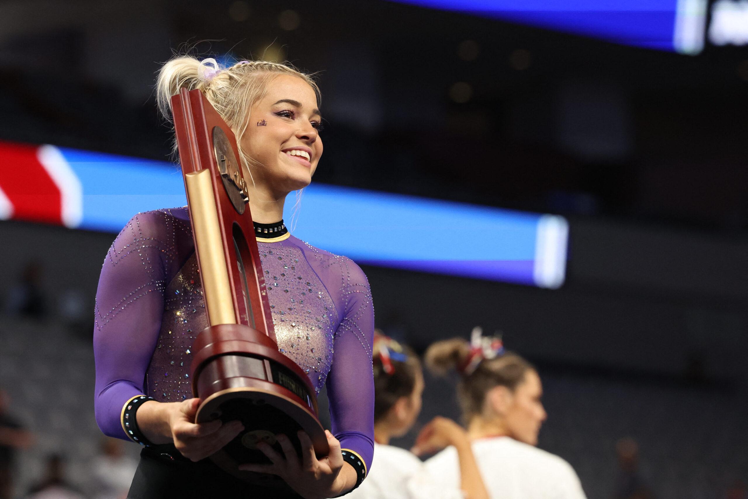 April 15, 2023: Olivia Dunne (LSU) poses with her team's fourth-place trophy after the 2023 NCAA National Collegiate Women's Gymnastics Championships Final at Dickies Arena in Fort Worth, Texas. Melissa J. Perenson/Cal Sport Media(Credit Image: © Melissa J. Perenson/Cal Sport Media) Newscom/(Mega Agency TagID: csmphotothree084670.jpg) [Photo via Mega Agency]