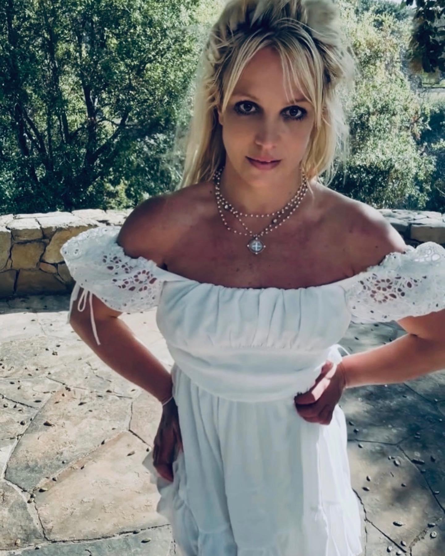 Britney Spears Tugs Down Her Sleeves To Make A Strapless Dress