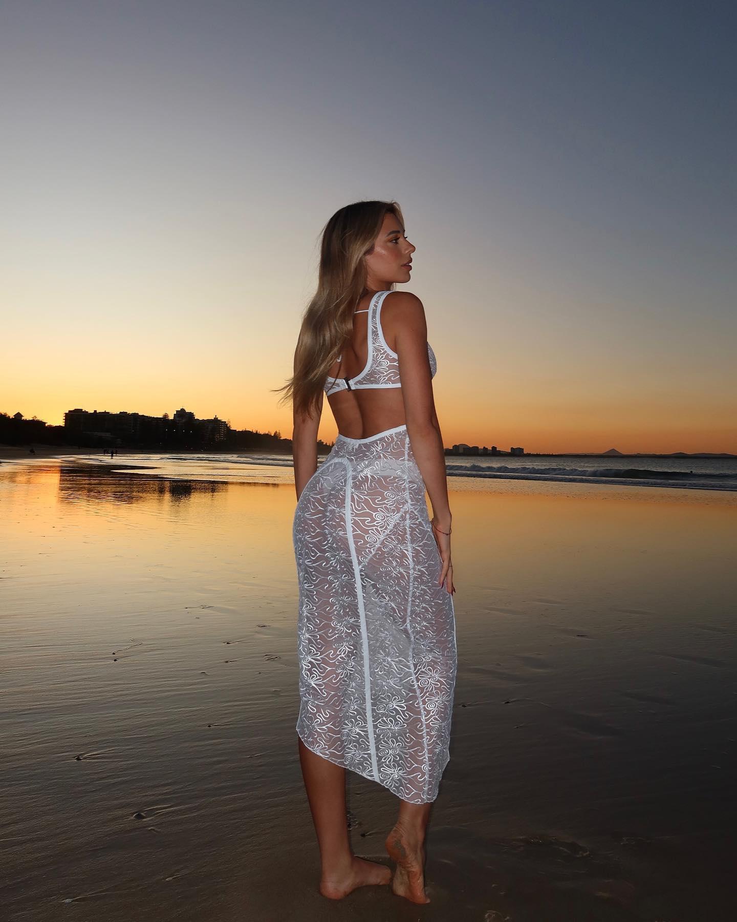 Georgia Hassarati Hits The Beach At Sunset In A See-Through Dress