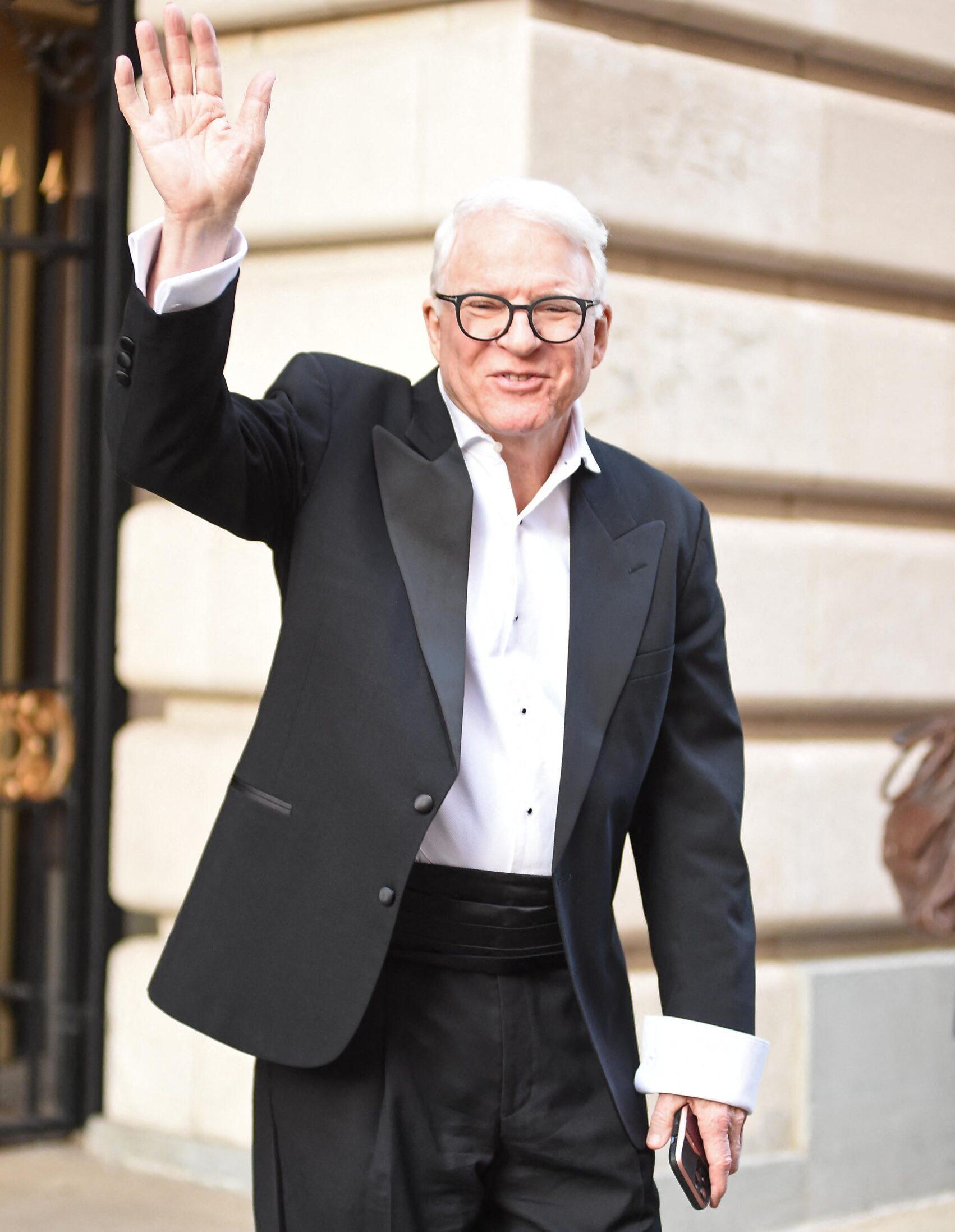 Steve Martin waves to fans as he seen leaving Only Murders in the building set