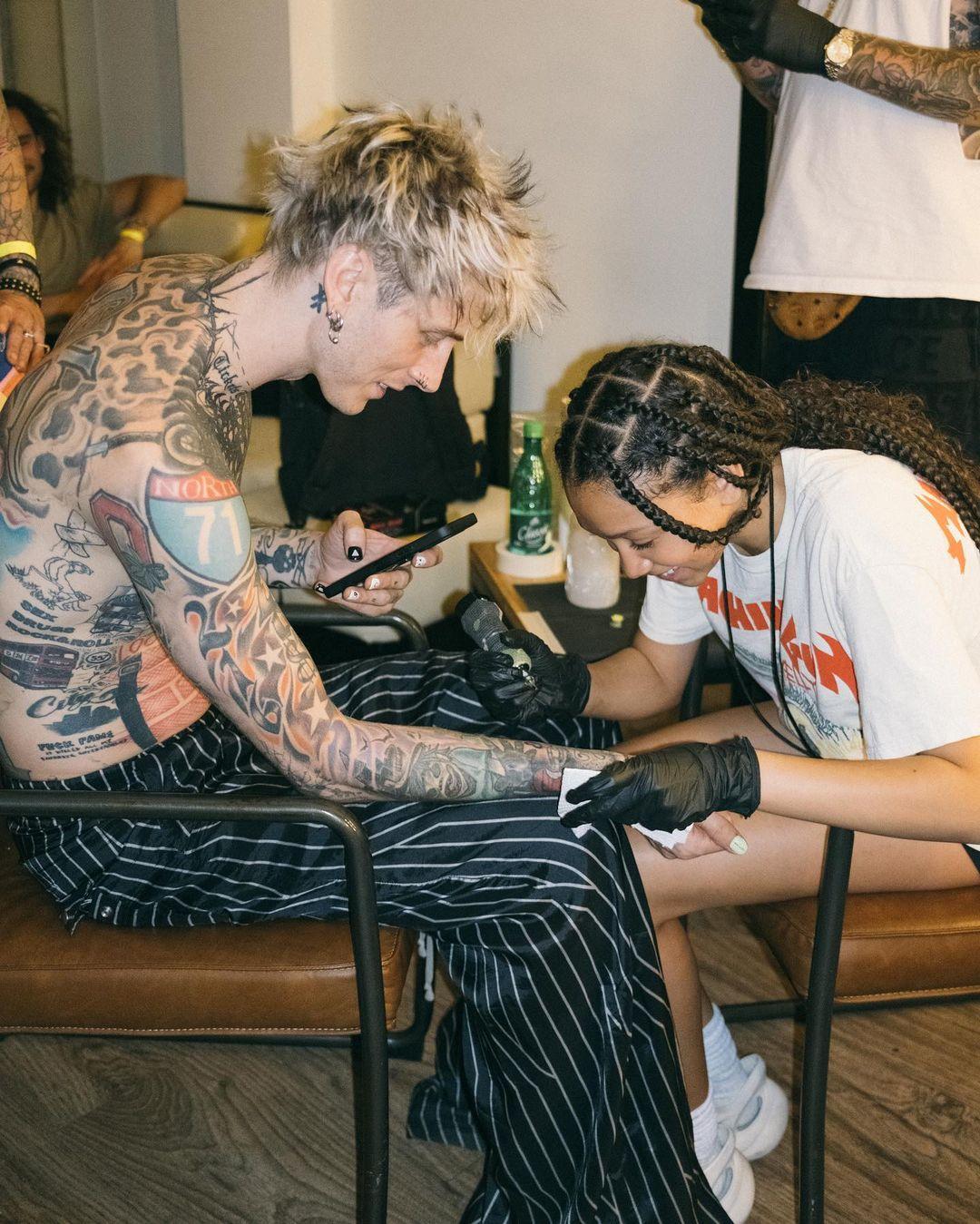 Machine Gun Kelly has his daughter Casie draw a tattoo on him