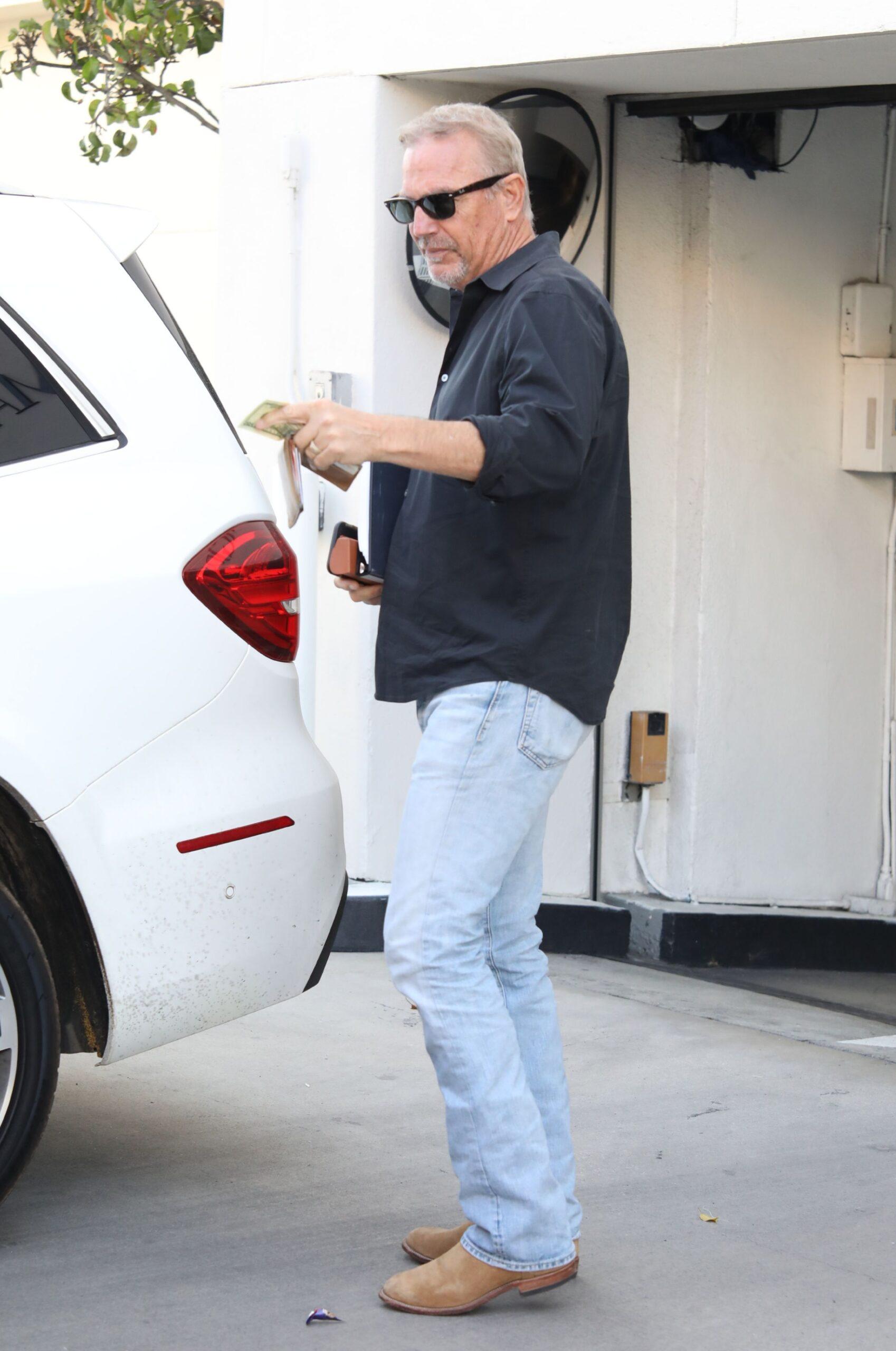 Kevin Costner is all smiles as he tips the valet