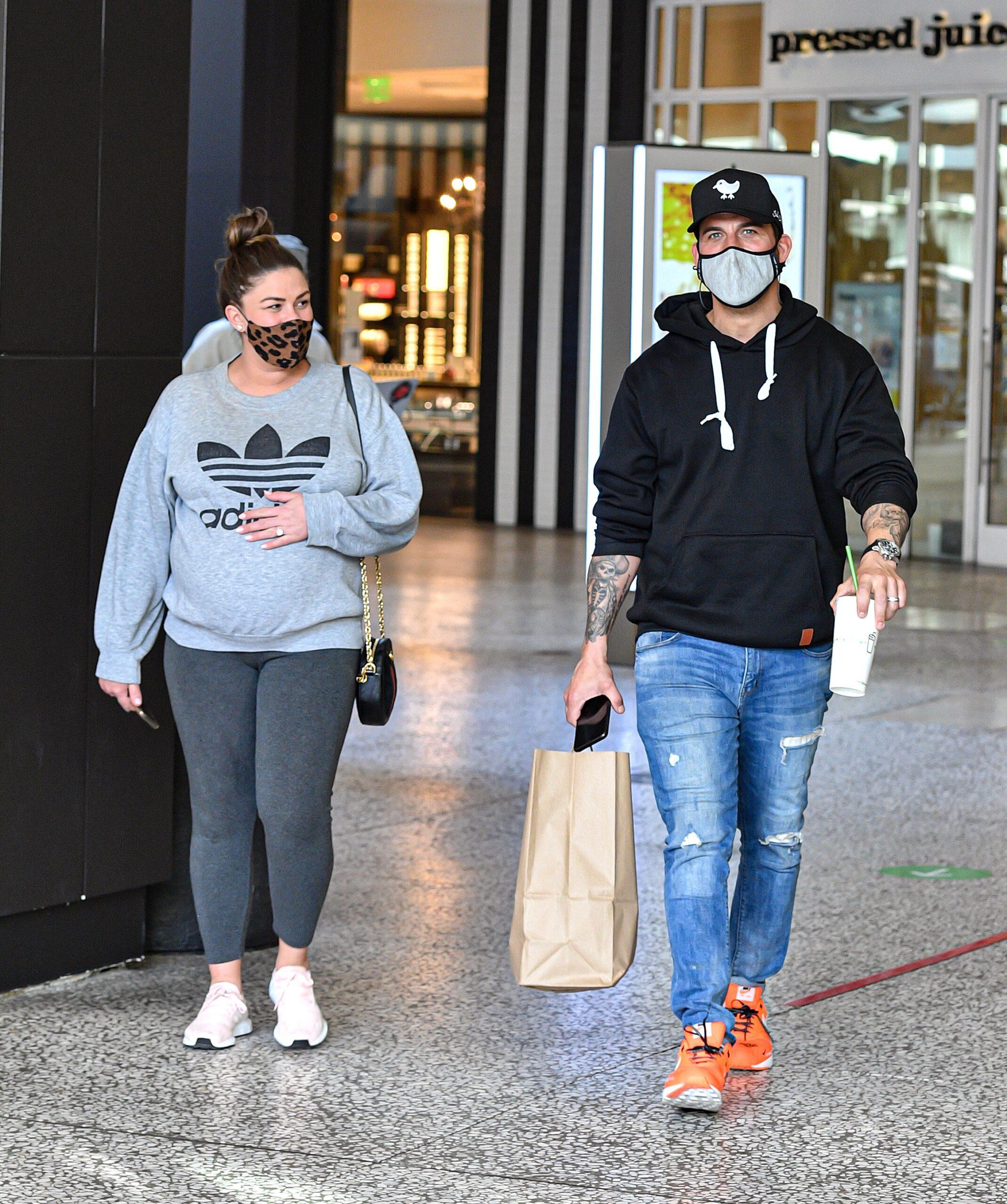 Brittany Cartwright is spotted holding onto her growing baby bump while shopping at the Century City Westfield Center with husband Jax Taylor in Los Angeles CA