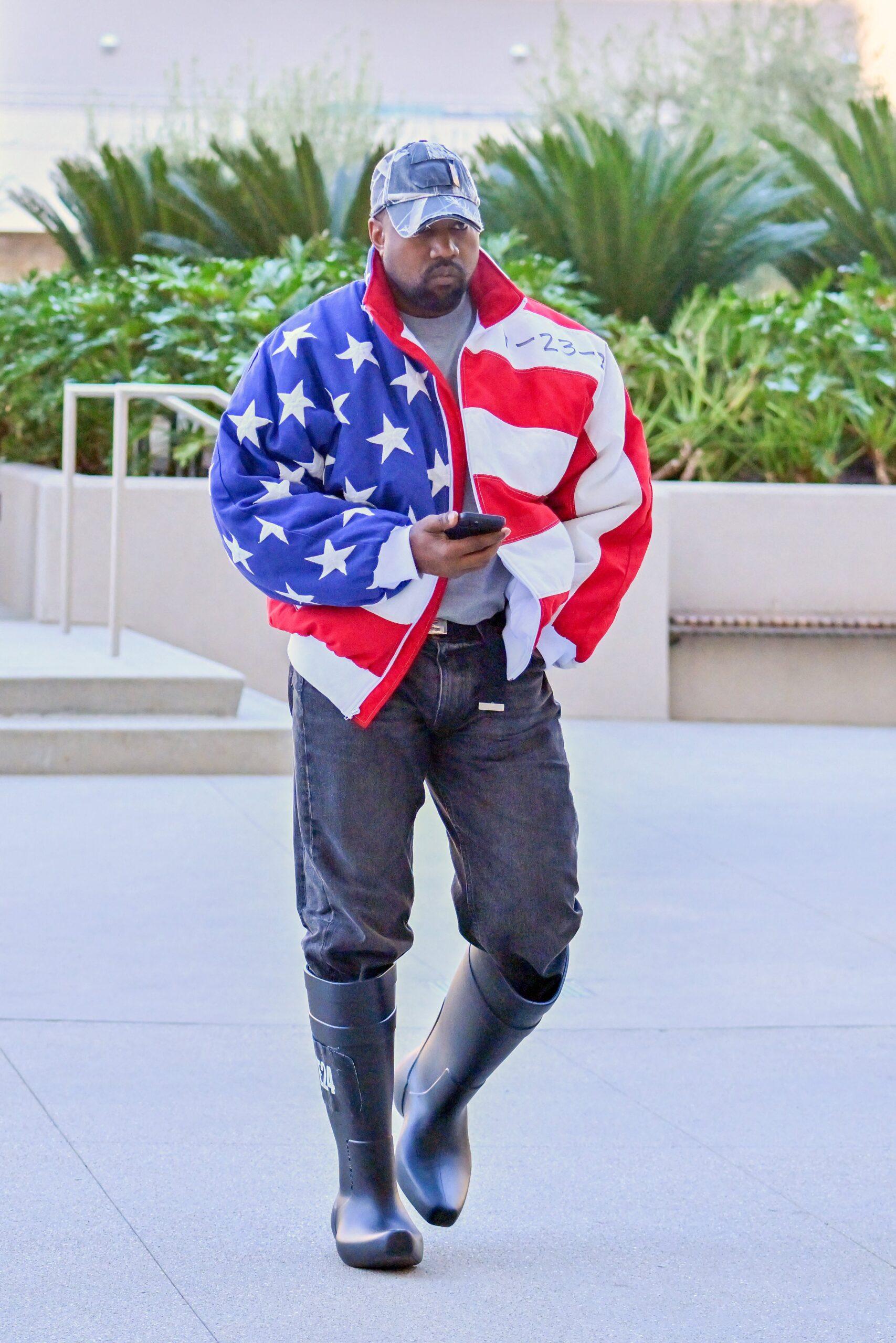 Kanye West heads to a meeting after heading to church wearing an American flag jacket