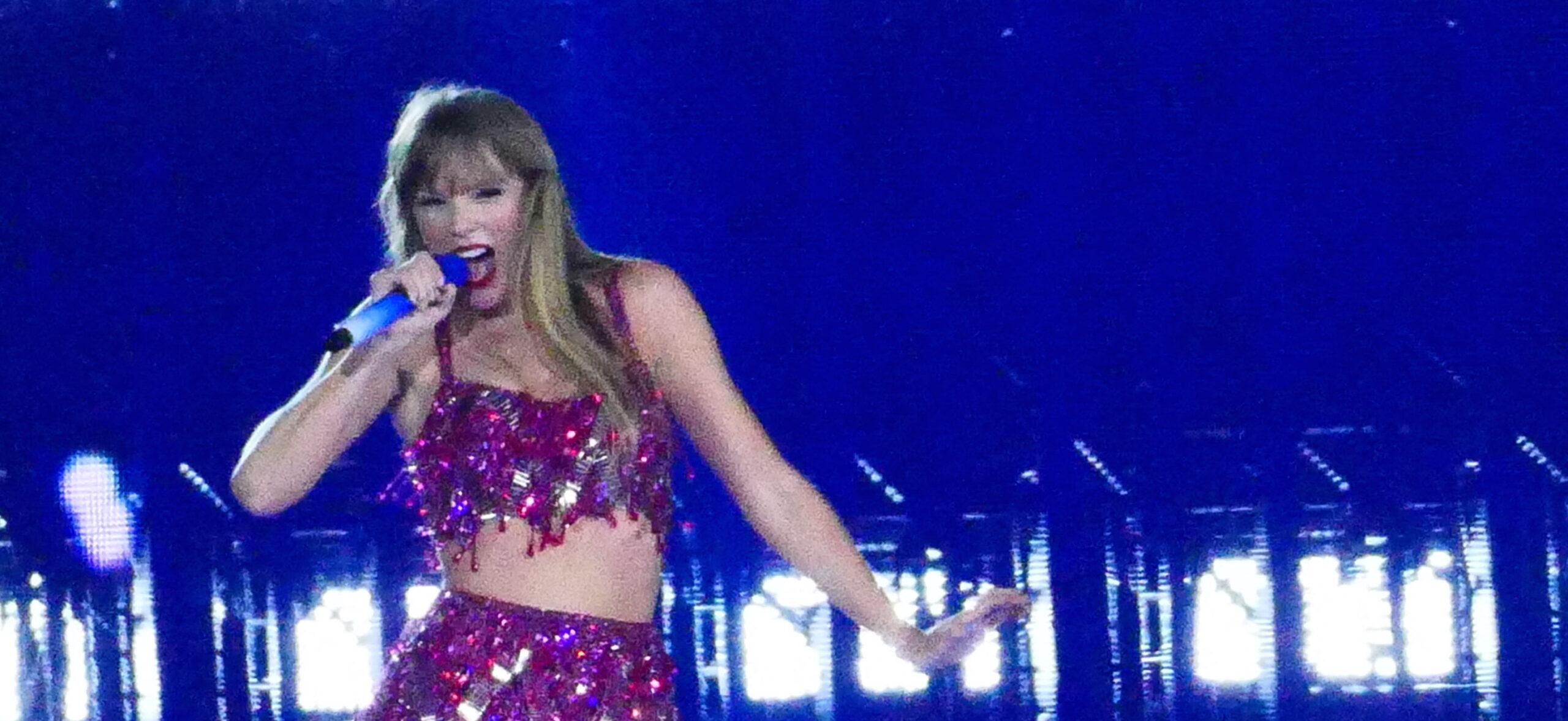 Taylor Swift holds a light saber style prop as bicycles and cars go by her in amazing visual show on stage during first weekend of her tour in Arizona