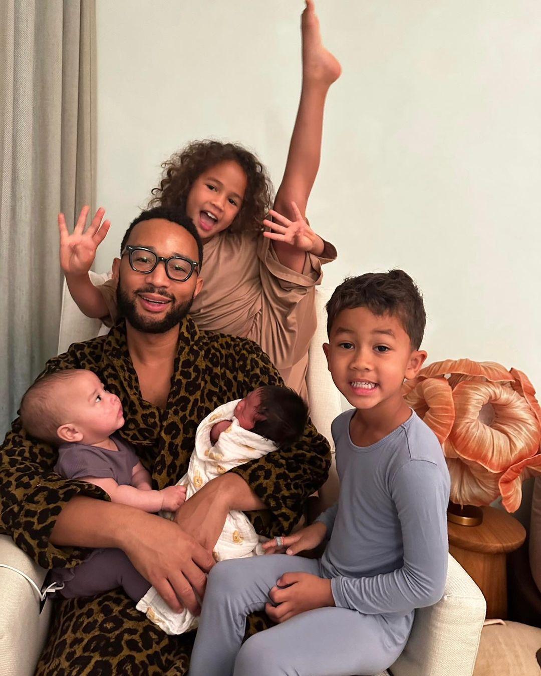 John Legend poses with all four of his and Chrissy Teigen's babies