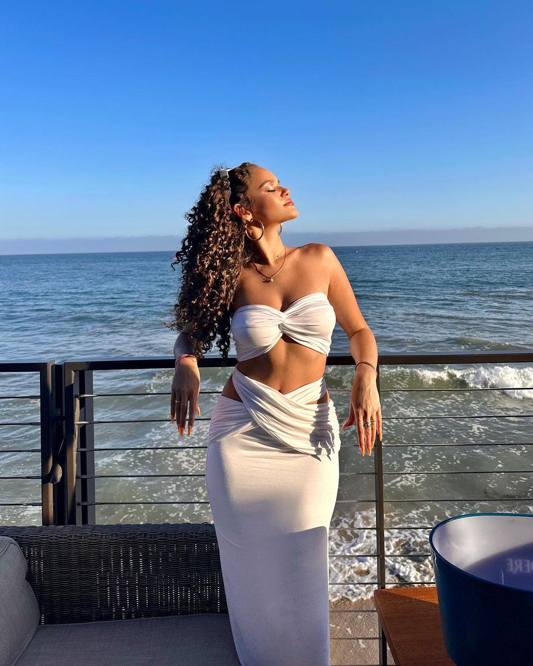 Madison Pettis strikes a pose in her white crochet tube top and matching skirt.