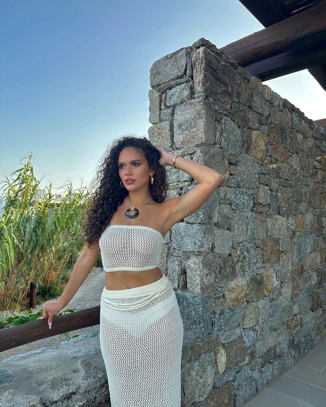 Madison Pettis strikes a pose in her white crochet tube top and matching skirt.