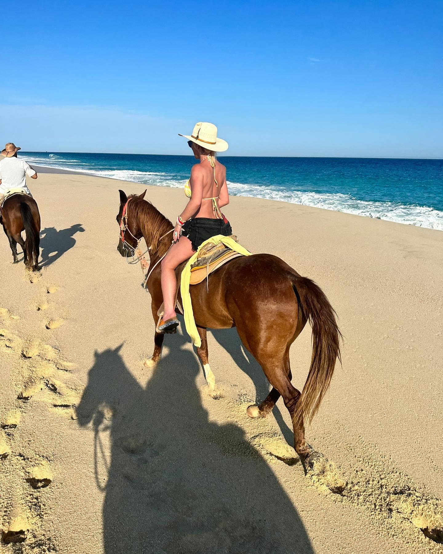 Britney Spears rides a horse on a beach in Mexico in a bikini