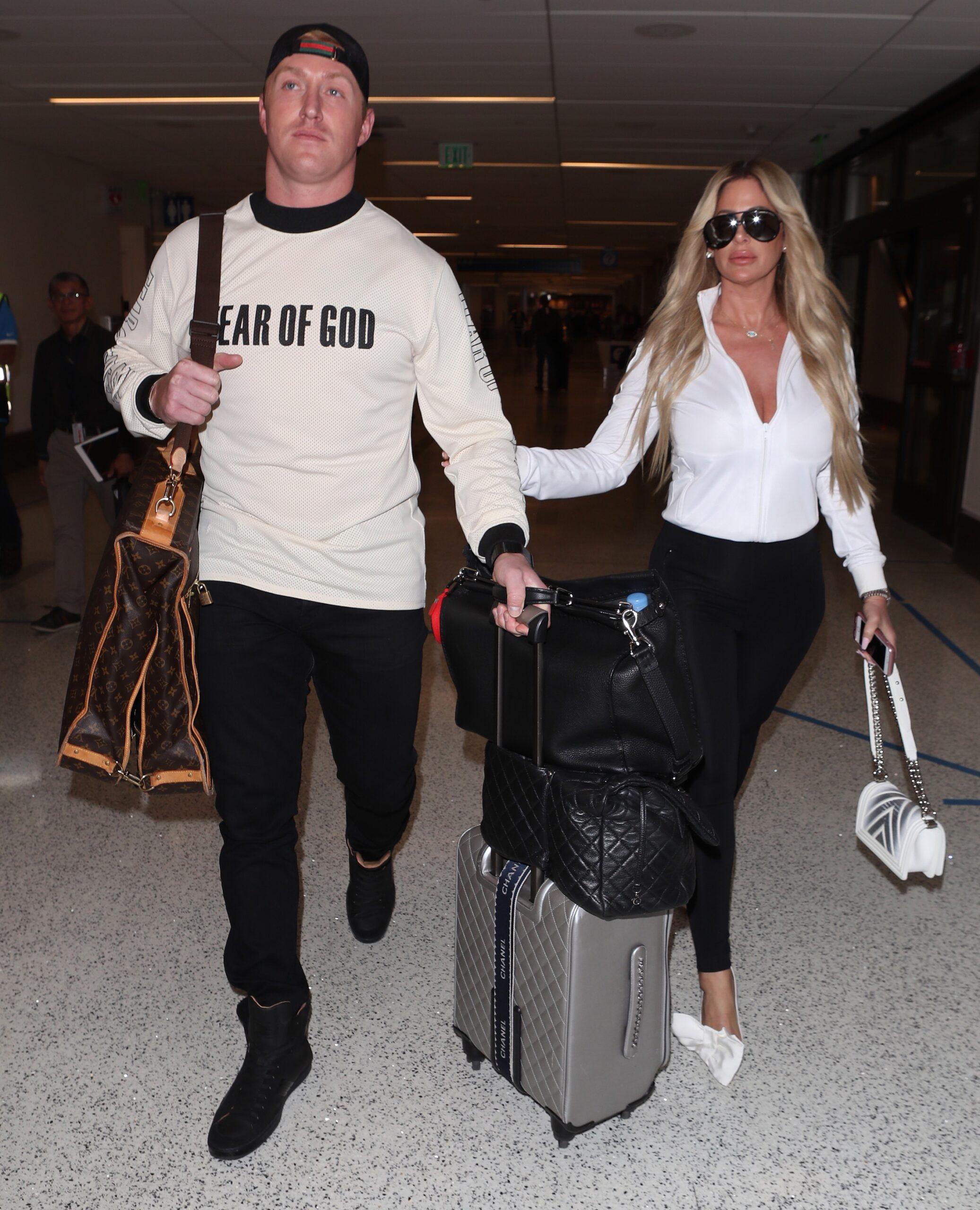 Kim Zolciak makes a sexy arrival as she is spotted at LAX with husband Kroy
