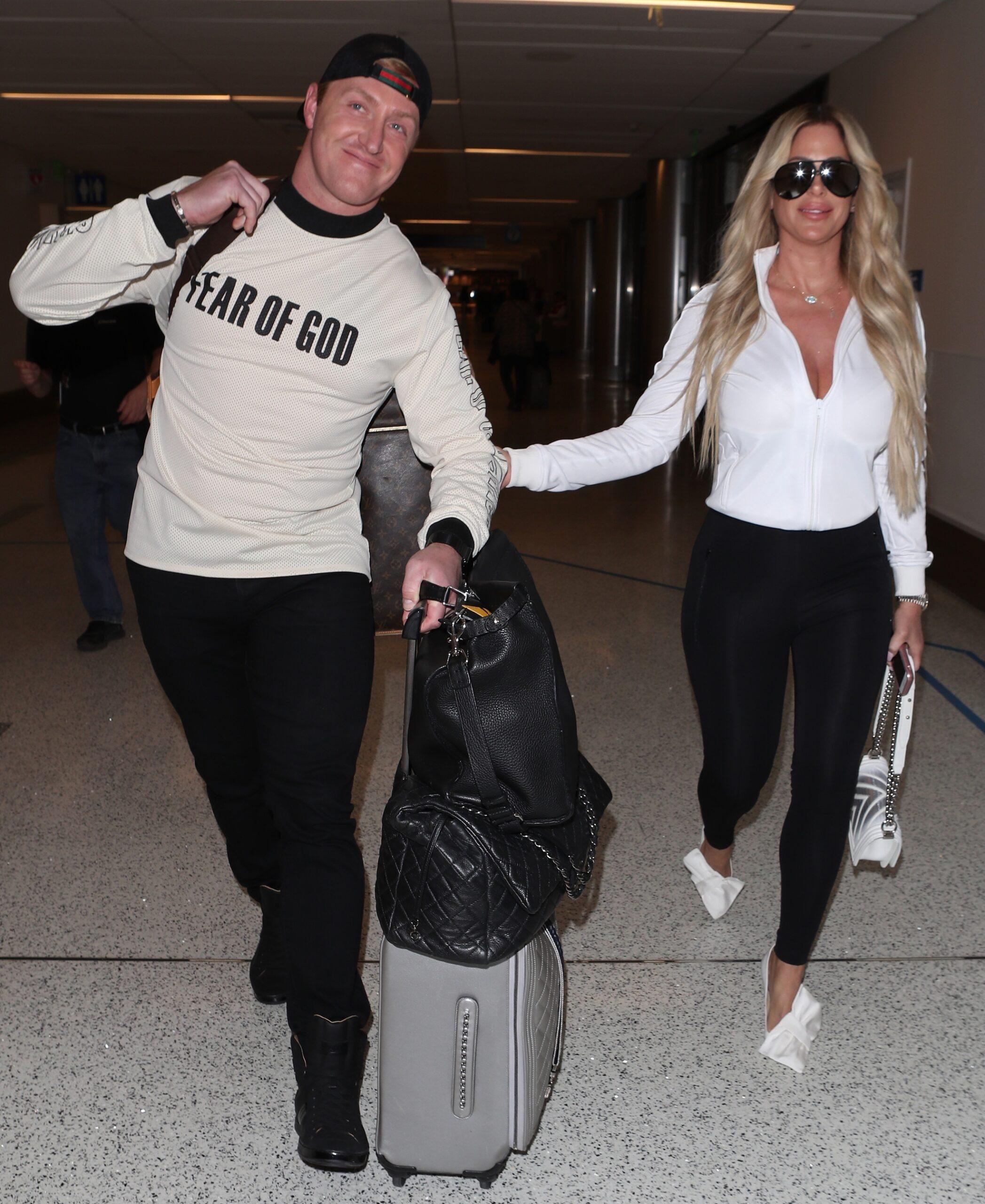 Kim Zolciak makes a sexy arrival as she is spotted at LAX with husband Kroy