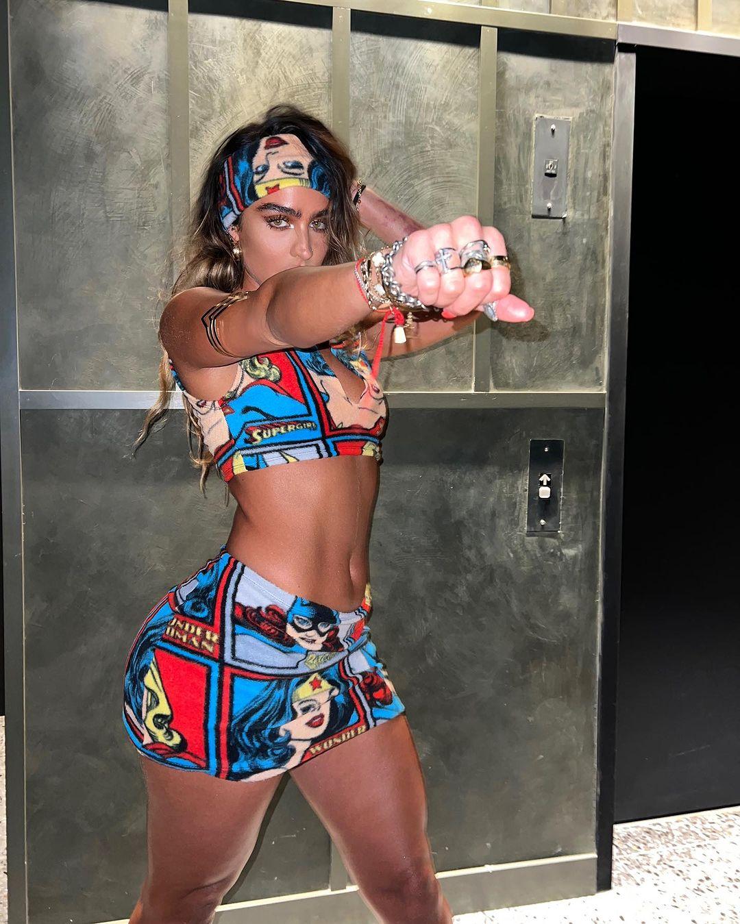Sommer Ray wears a tiny crop top and skirt with a Wonder Woman print.