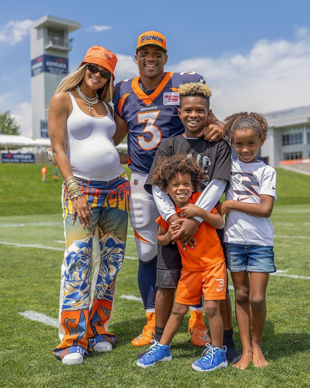 A portrait of pregnant Ciara and her husband Russell Wilson with their kids