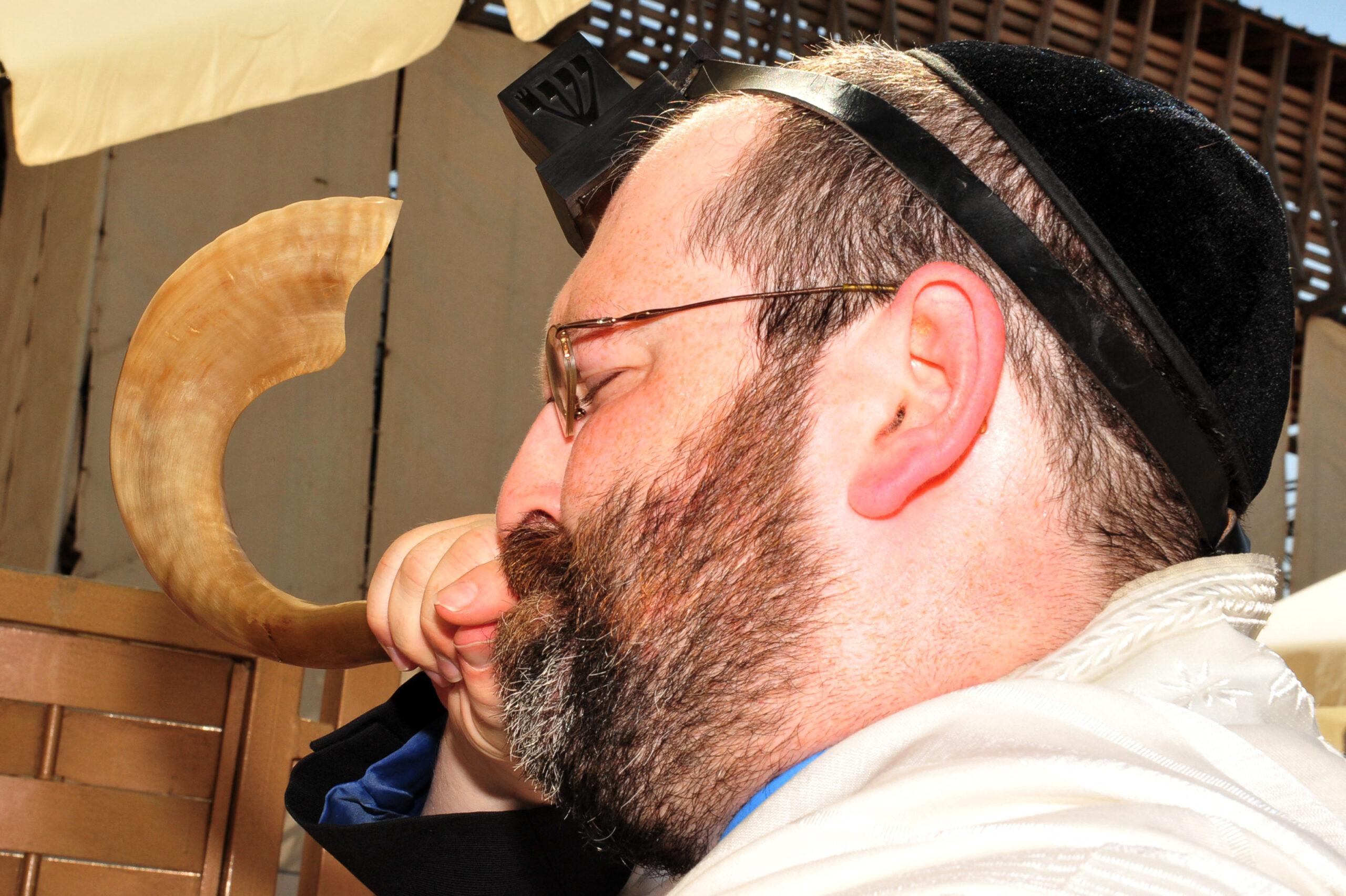 Jewish man blowing the Shofar at the Kotel on September 22 2008 in Jerusalem, Israel.It's a horn used for Jewish religious purposes on Rosh Hashanah and Yom Kippur Jewish Holidays