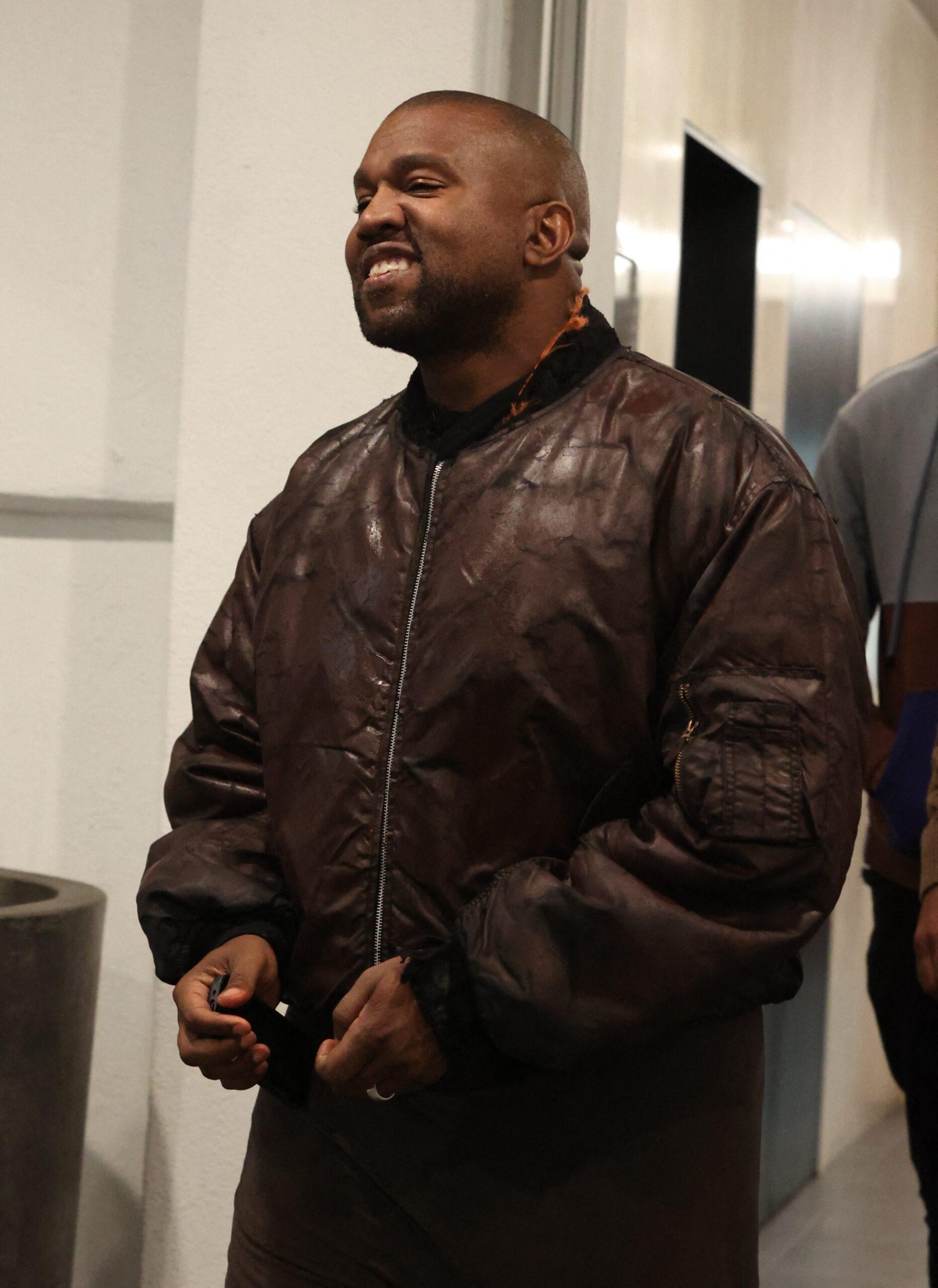 Kanye smiles brightly after dining with friends at e.baldi restaurant.