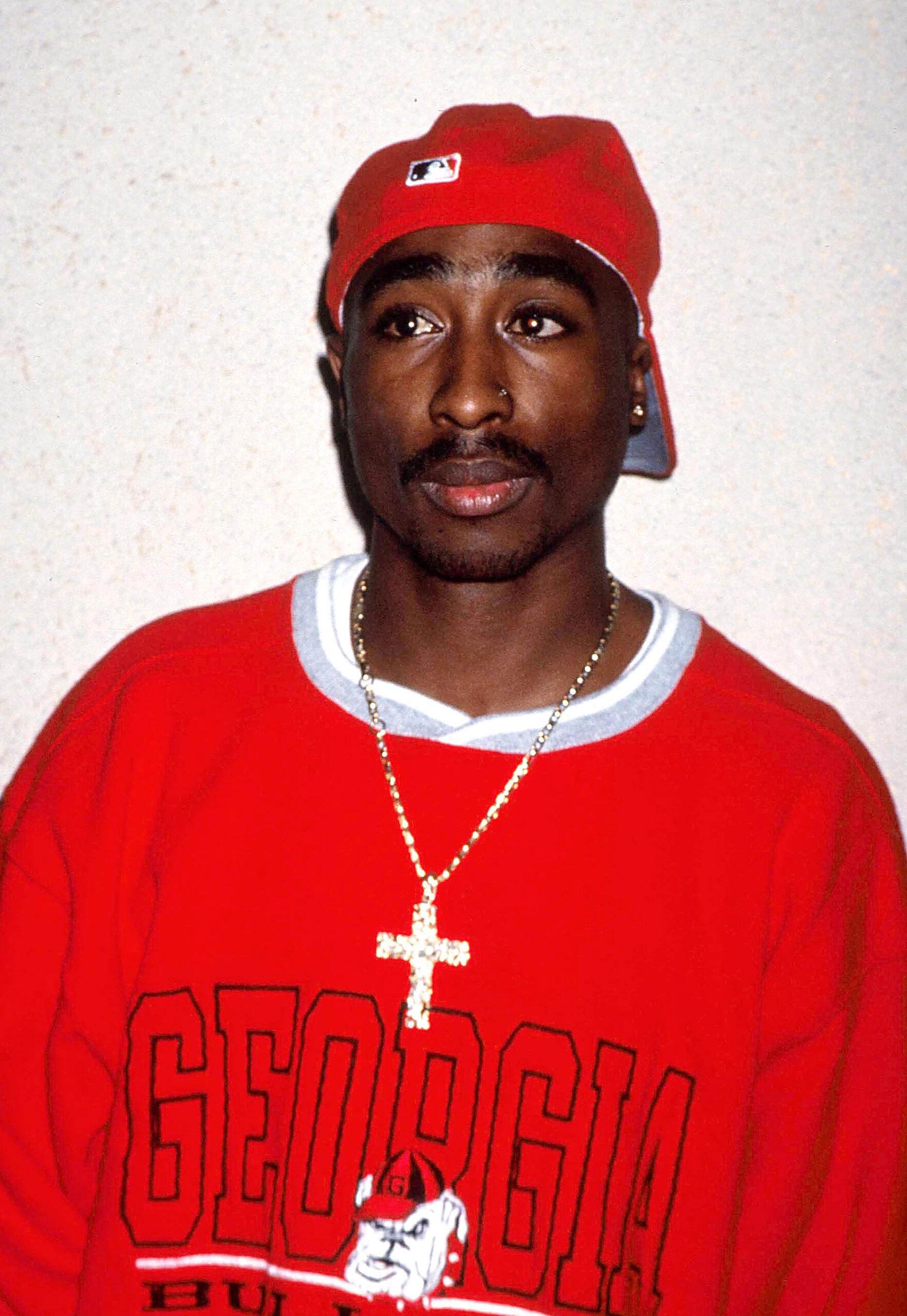 TUPAC SHAKUR wearing jewelry gold and Georgia 'Bloods' gangster color red sweater. 03 Jun 2003