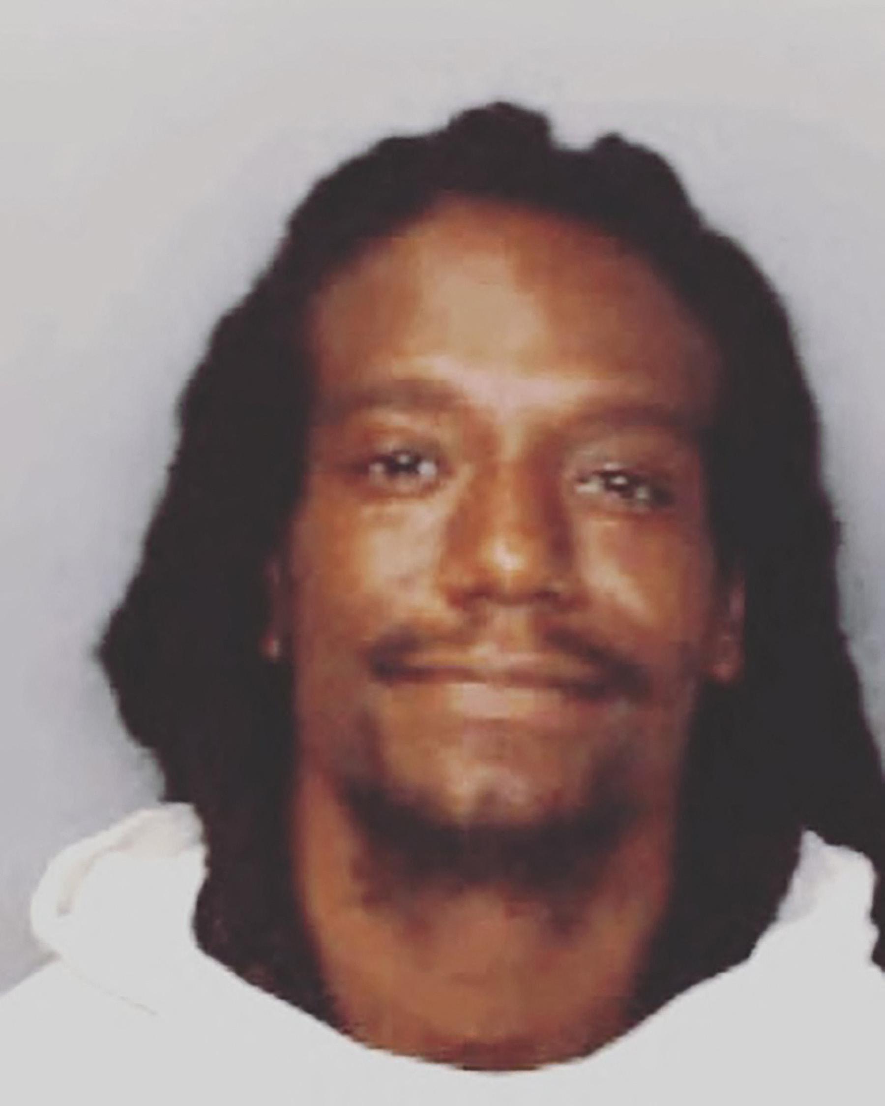 Ex-NFL star Sergio Brown grins after being arrested over the murder of his mother.
