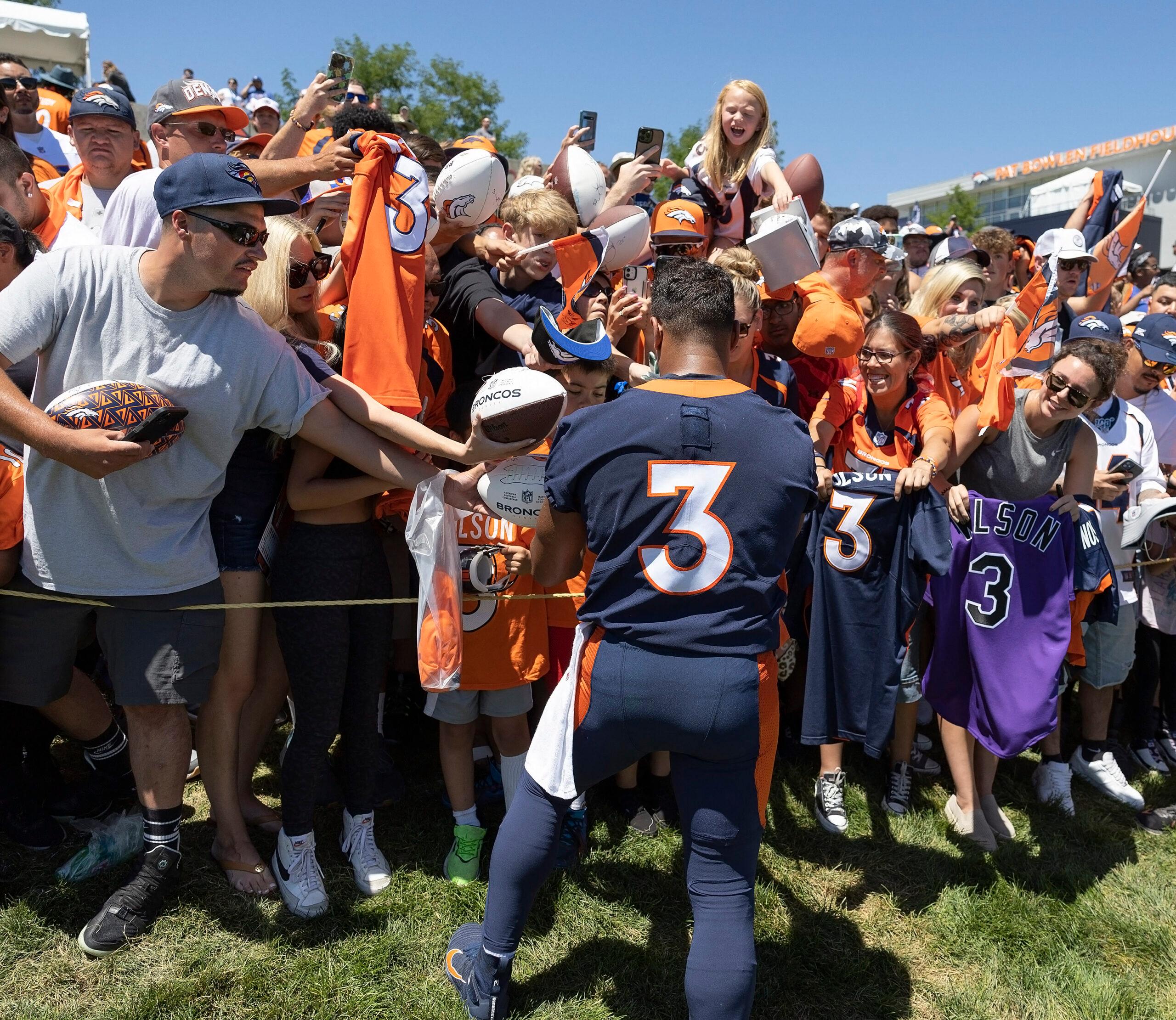 Russell Wilson signing autographs at NFL Training Camp - Denver Broncos Training Camp on Saturday morning.