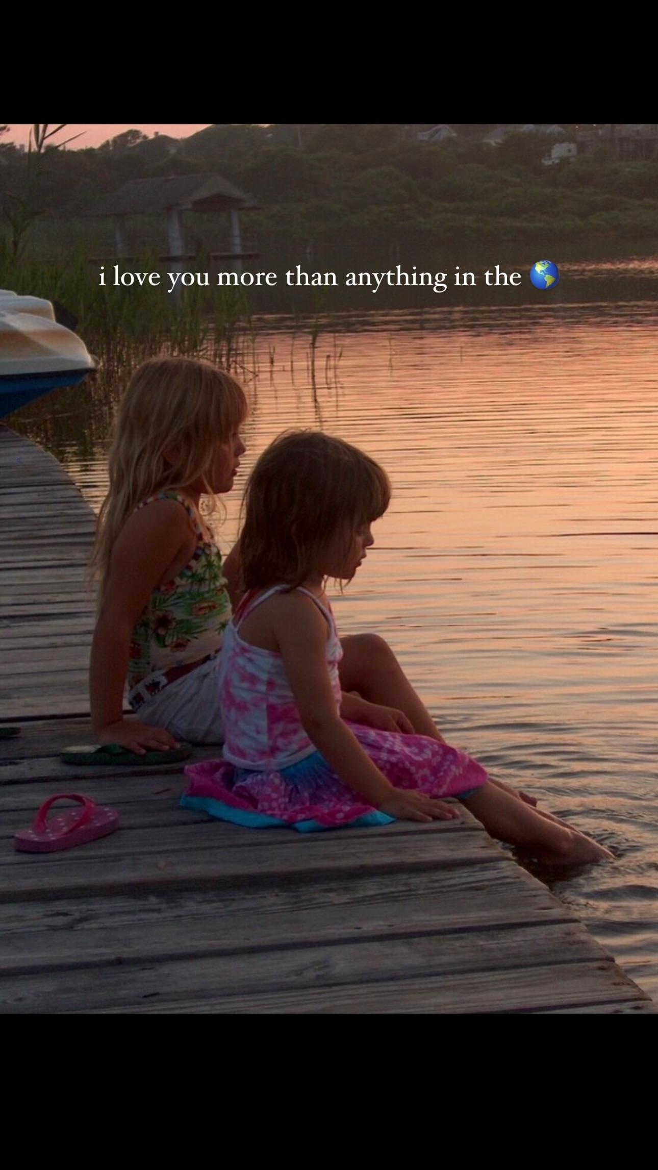 Julz and Olivia Dunne when they were kids sitting by the lake.