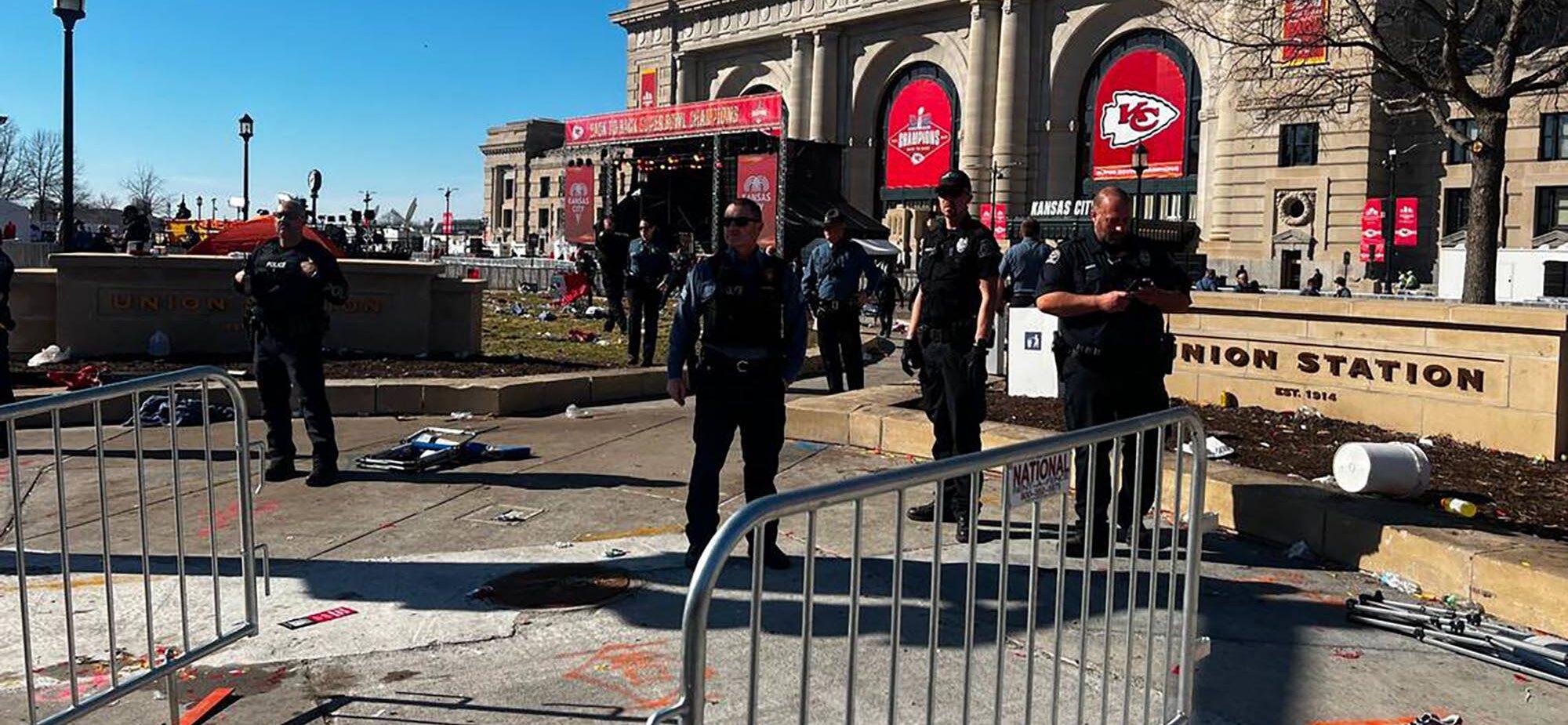Police officers investigate the scene of a shooting where at least one person was killed and more than 20 others were injured after the Kansas City Chiefs Super Bowl LVIII victory parade