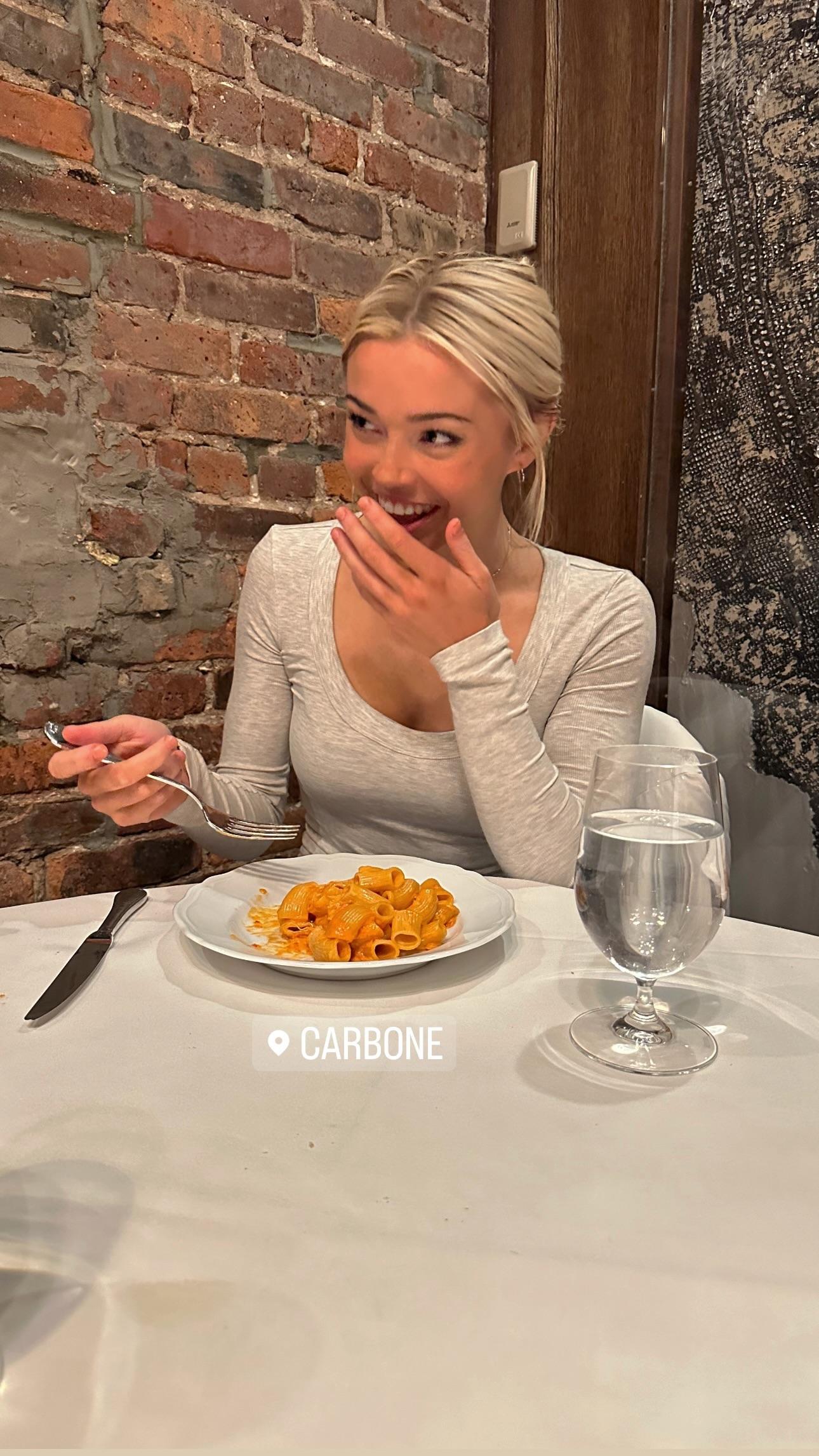 Olivia Dunne eating pasta in New York City.