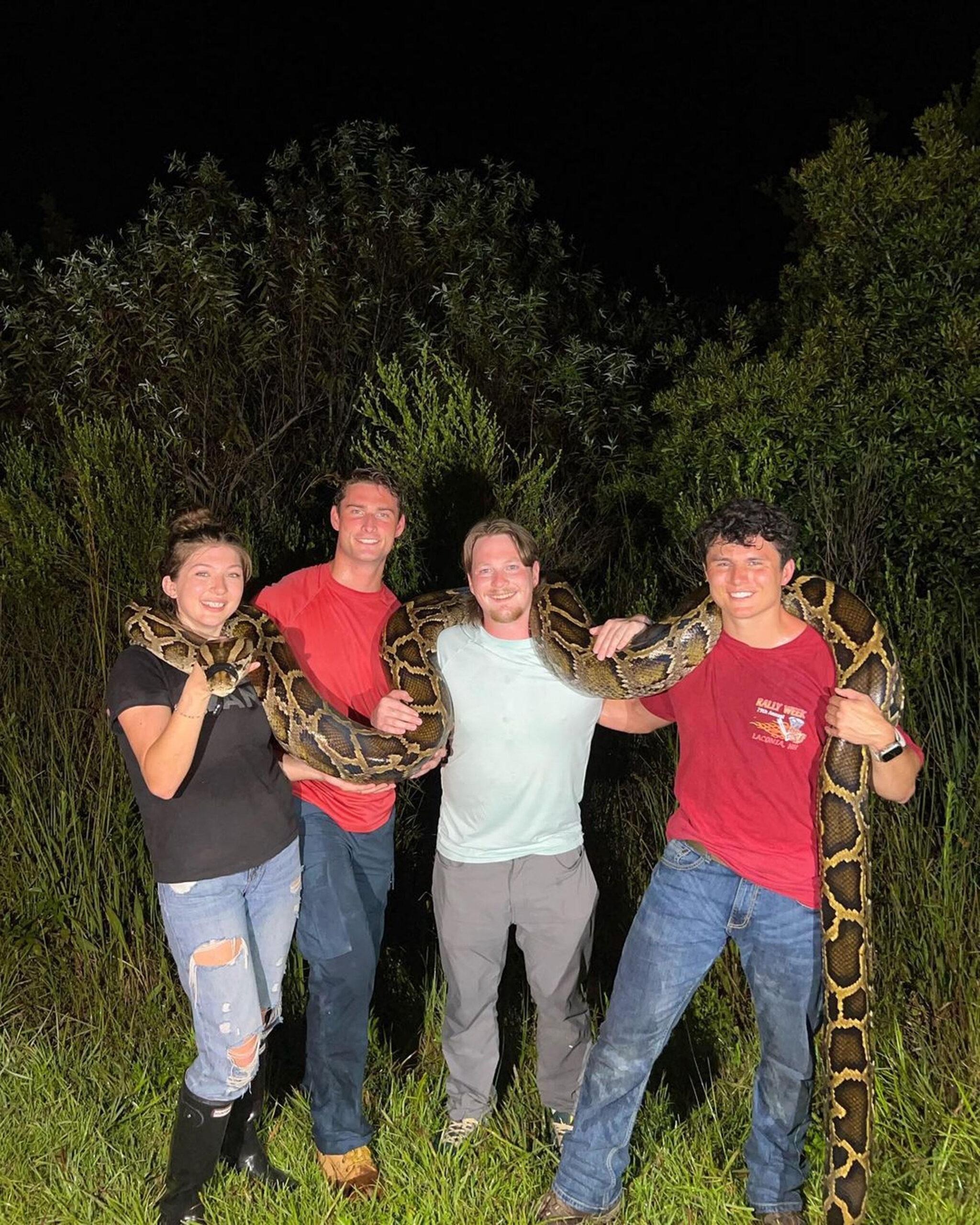 Python hunters show off record-breaking 19-foot Burmese python - the longest ever caught in Florida