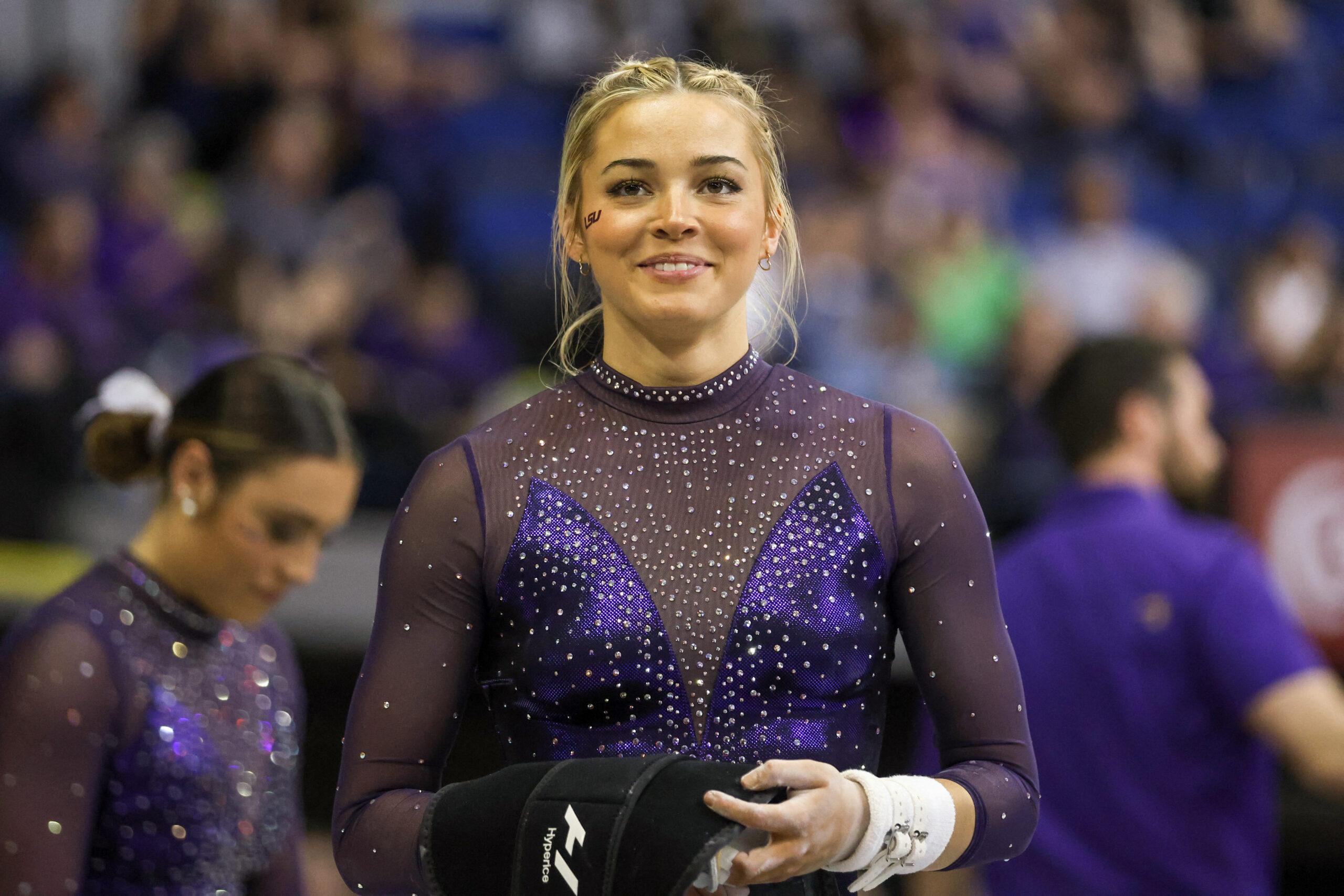 March 8, 2024: LSU's Olivia Dunne smiles to a fan during the Purple and Gold Podium Challenge woman's gymnastics quad meet at the Raising Canes River Center in Baton Rouge, LA. Jonathan Mailhes/CSM (Credit Image: © Jonathan Mailhes/Cal Sport Media) Newscom/(Mega Agency TagID: csmphotothree239106.jpg) [Photo via Mega Agency]