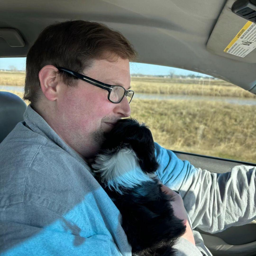 Ryan Anderson driving the car with dog on his lap