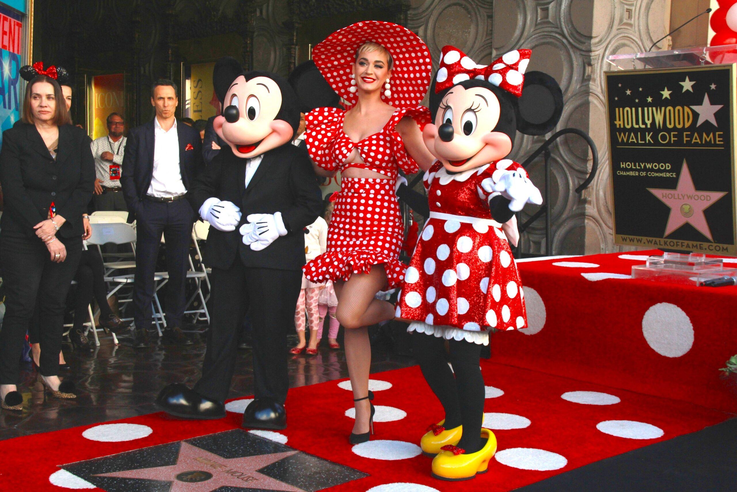 Katy Perry poses with Mickey Mouse and Minnie Mouse
