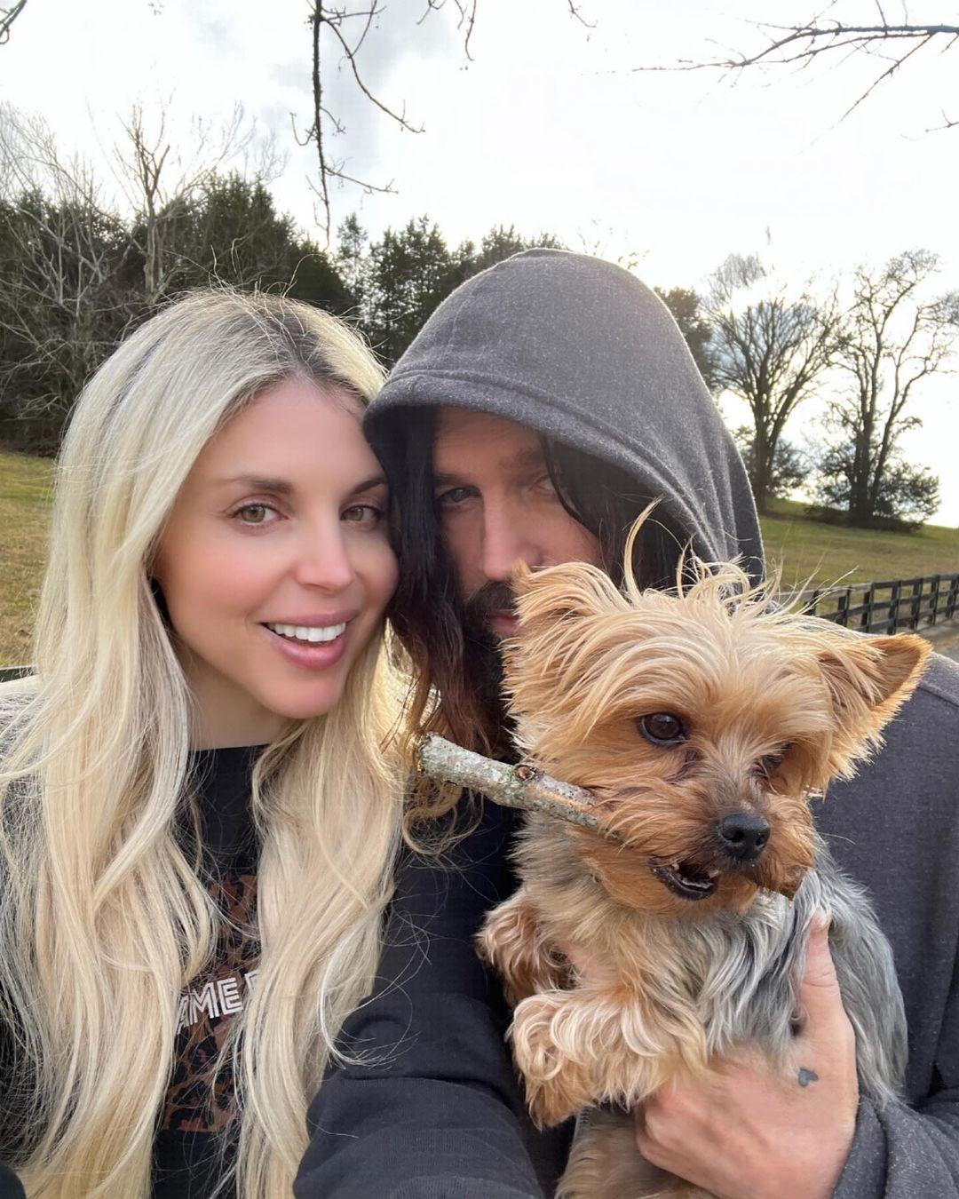 Billy Ray Cyrus and Firerose holding a dog