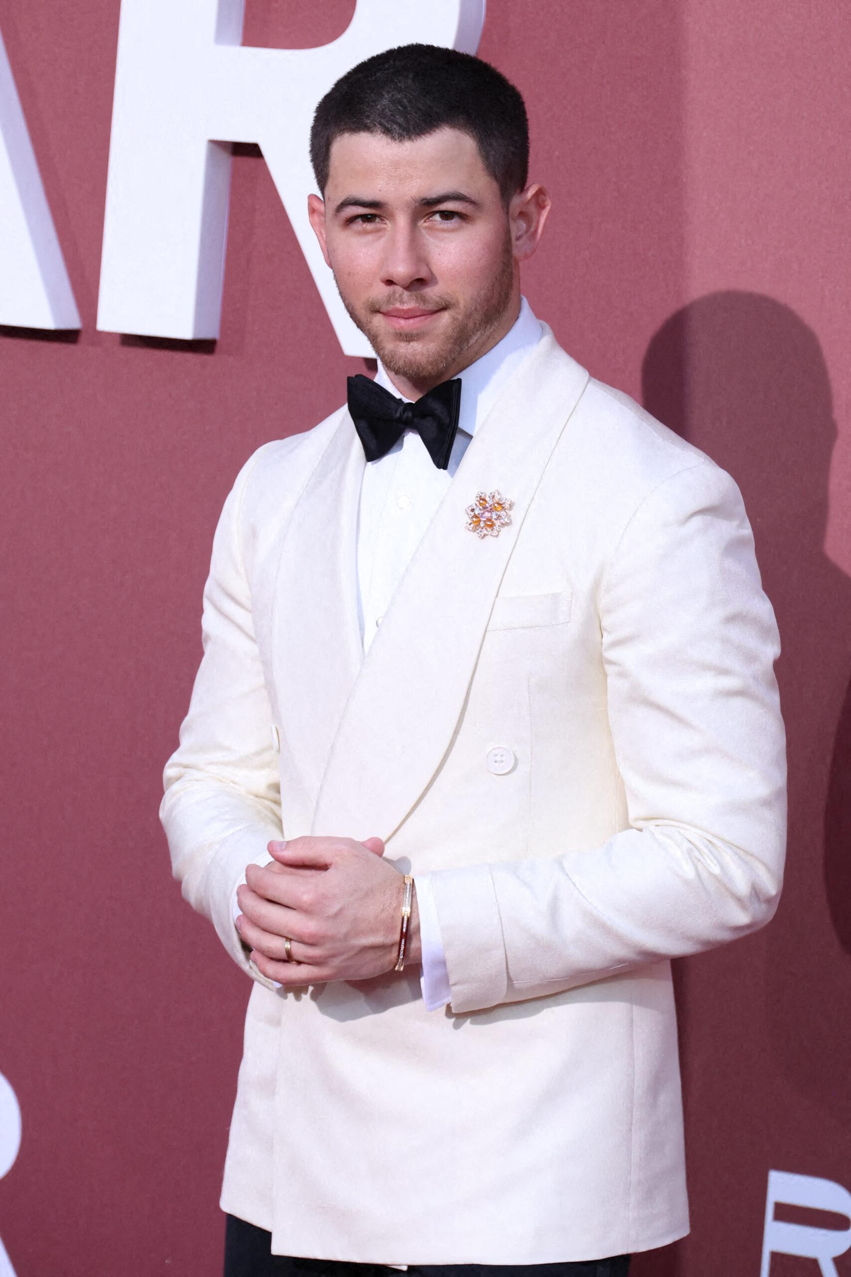 Nick Jonas wearing a white tux