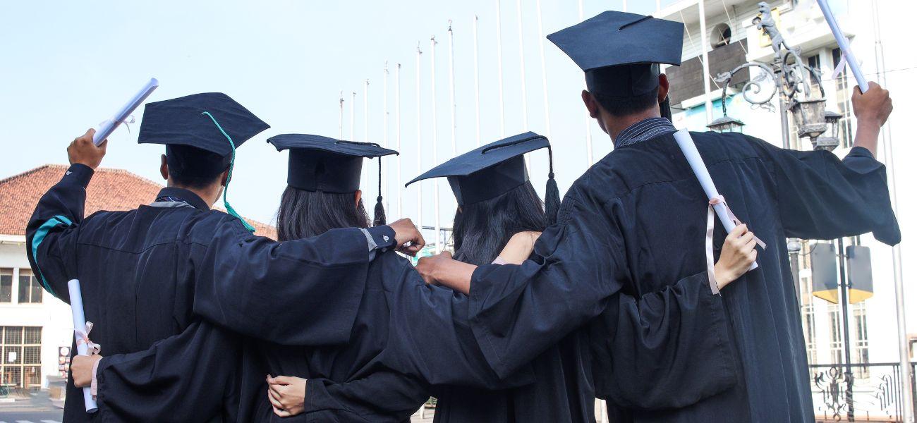 Students wearing graduation caps and gowns
