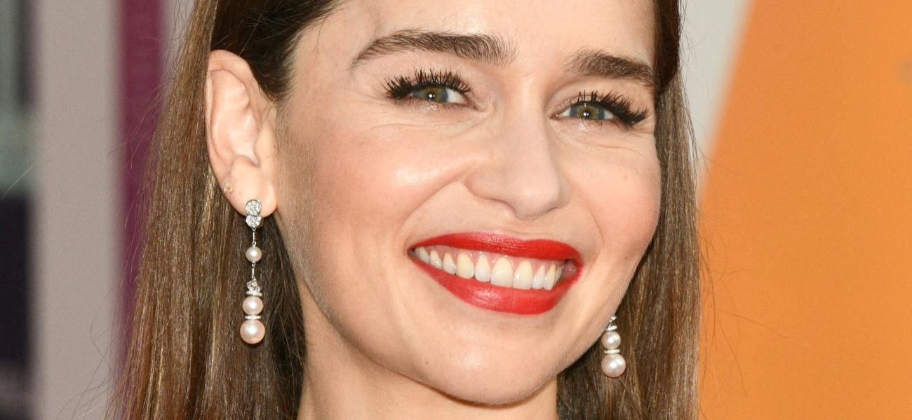 Emilia Clarke poses smiling