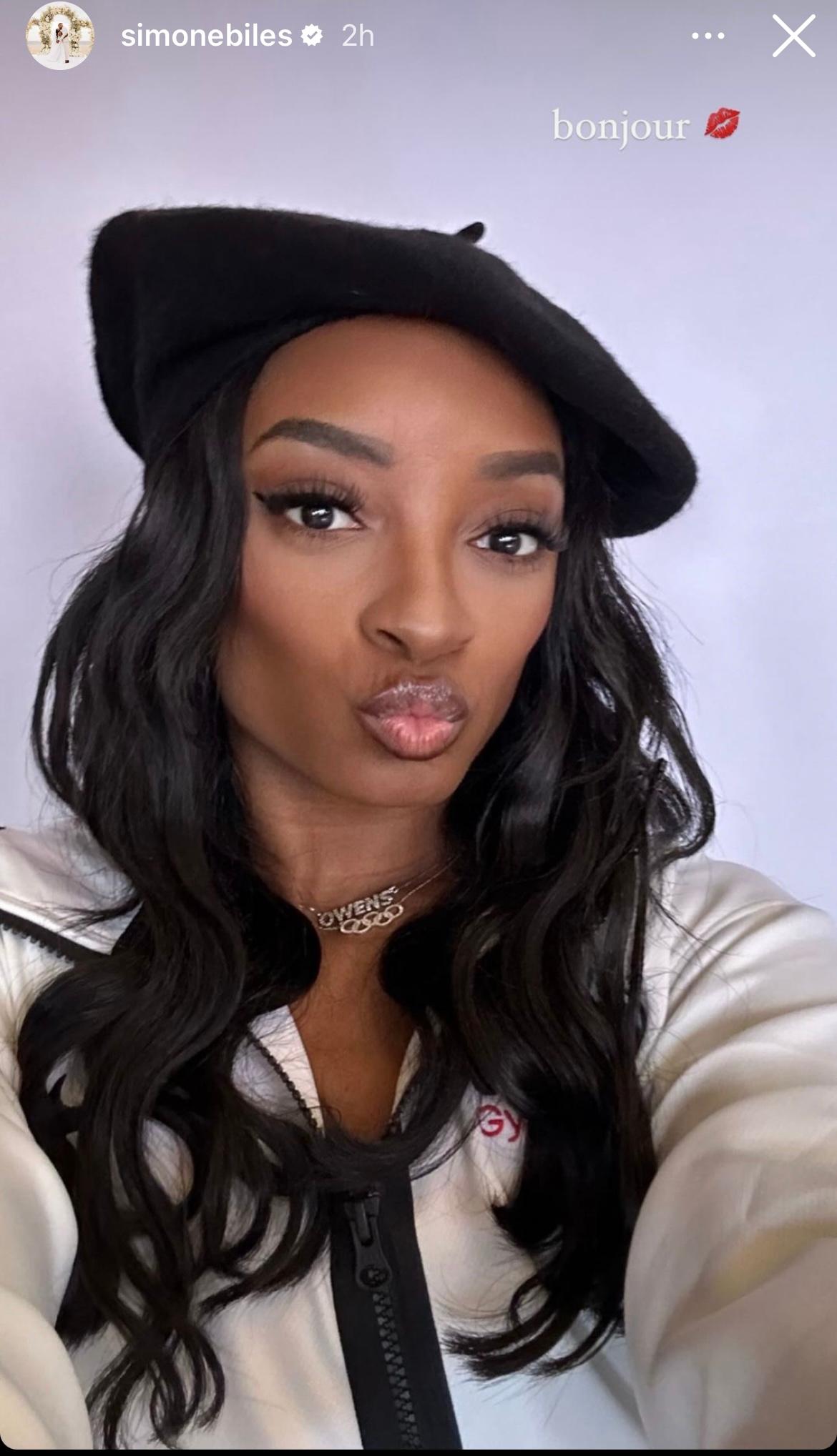 Simone Biles gives duck face while wearing a baret