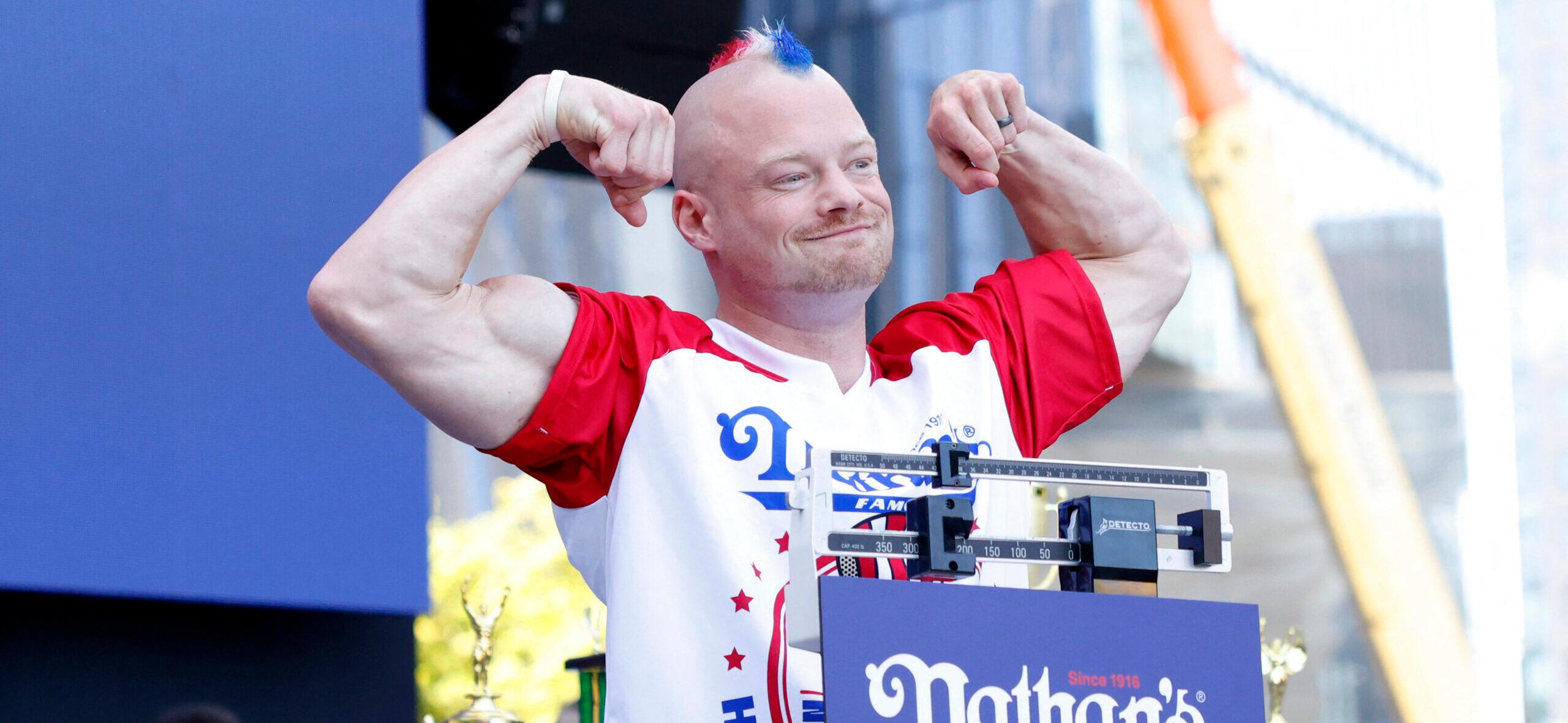 Nick Wehry stands on the scale at the 108th Nathan's Famous Fourth of July International Hot Dog Eating Contest