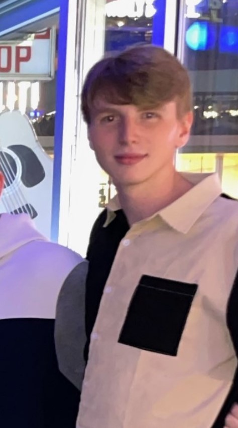 Riley Strain smiling in black and white shirt