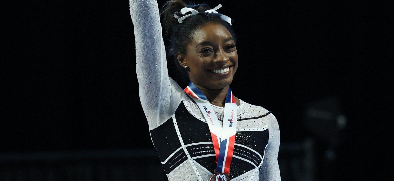 Simone Biles smiles as she takes home Olympic medal