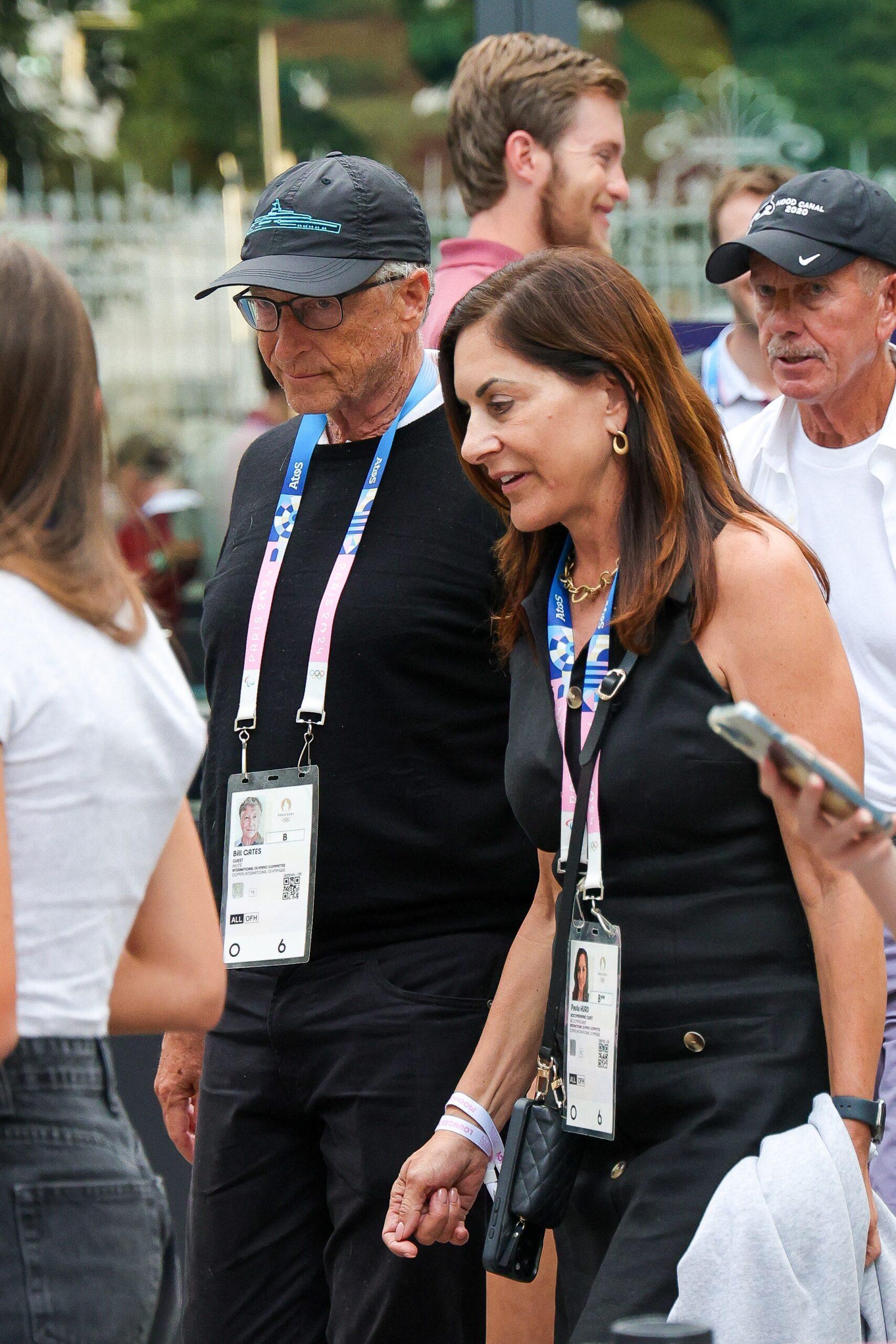 Bill Gates and Paula Hurd leave the Paris 2024 Olympic women's gymnastic final