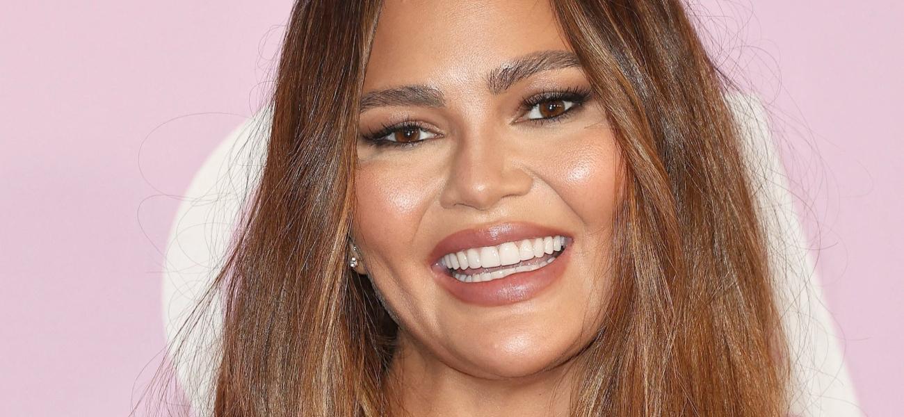 Chrissy Teigen smiles at an event