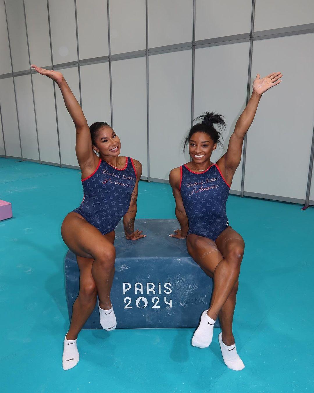 Jordan Chiles and Simone Biles pose in the gym