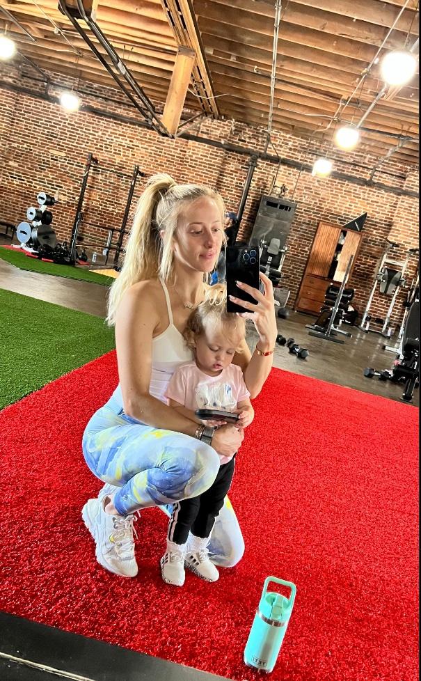 Brittany Mahomes takes a mirror selfie at the gym with her daughter