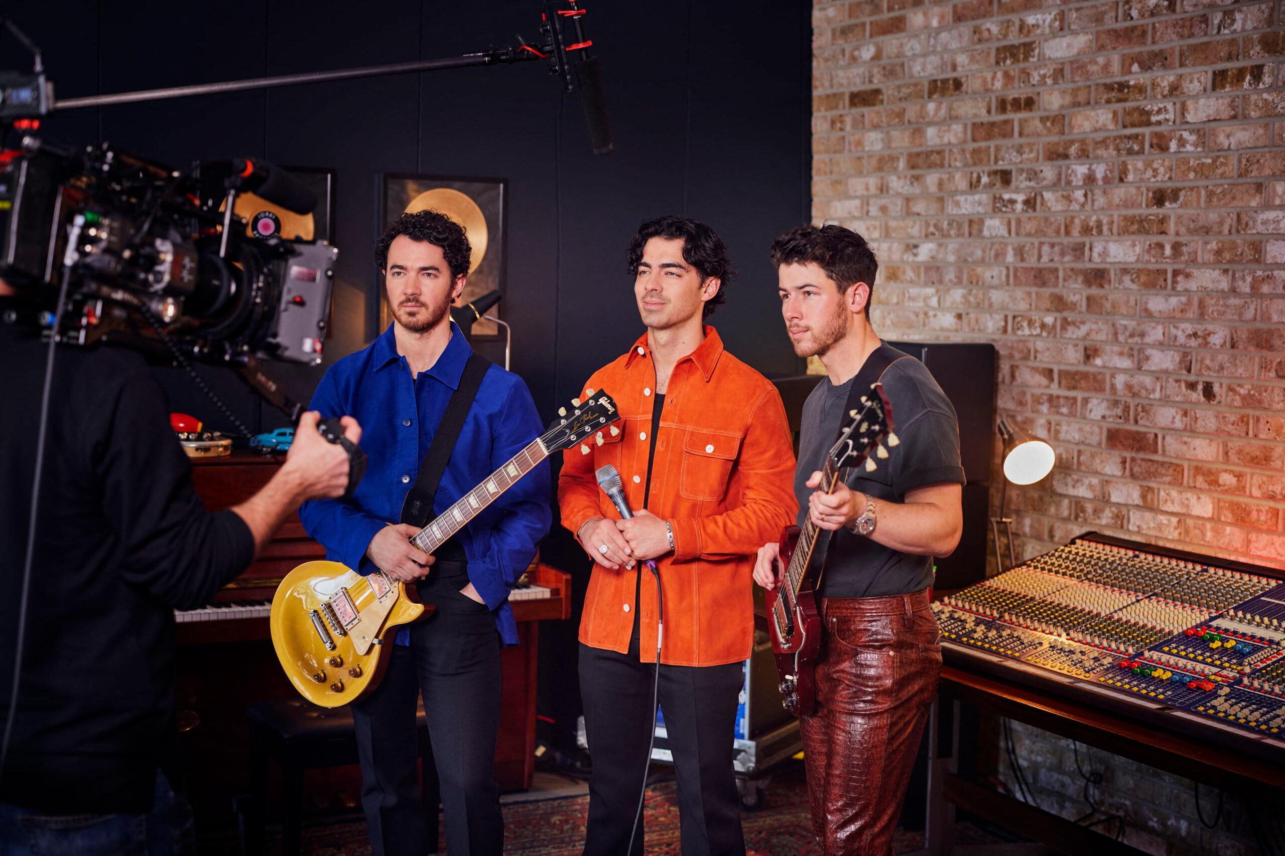 Kevin Jonas, Joe Jonas, and Nick Jonas get ready to perform