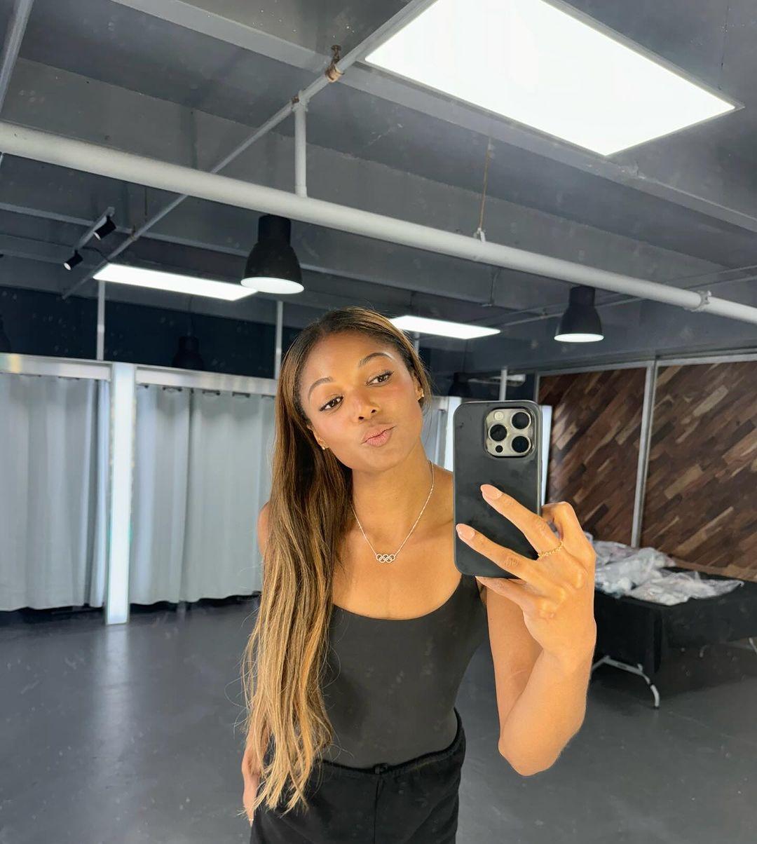 Gabby Thomas takes a mirror selfie in the gym