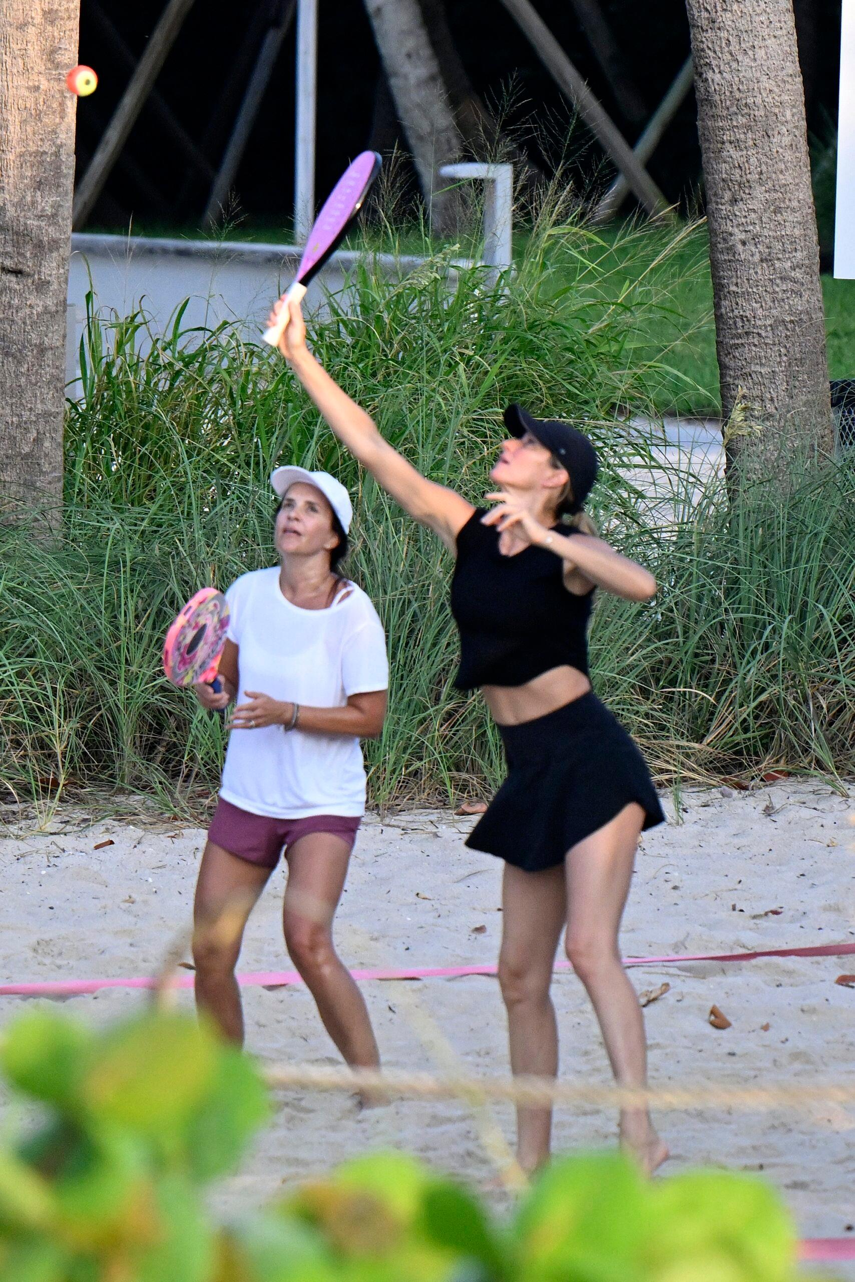 Gisele Bundchen playing beach tennis with a friend