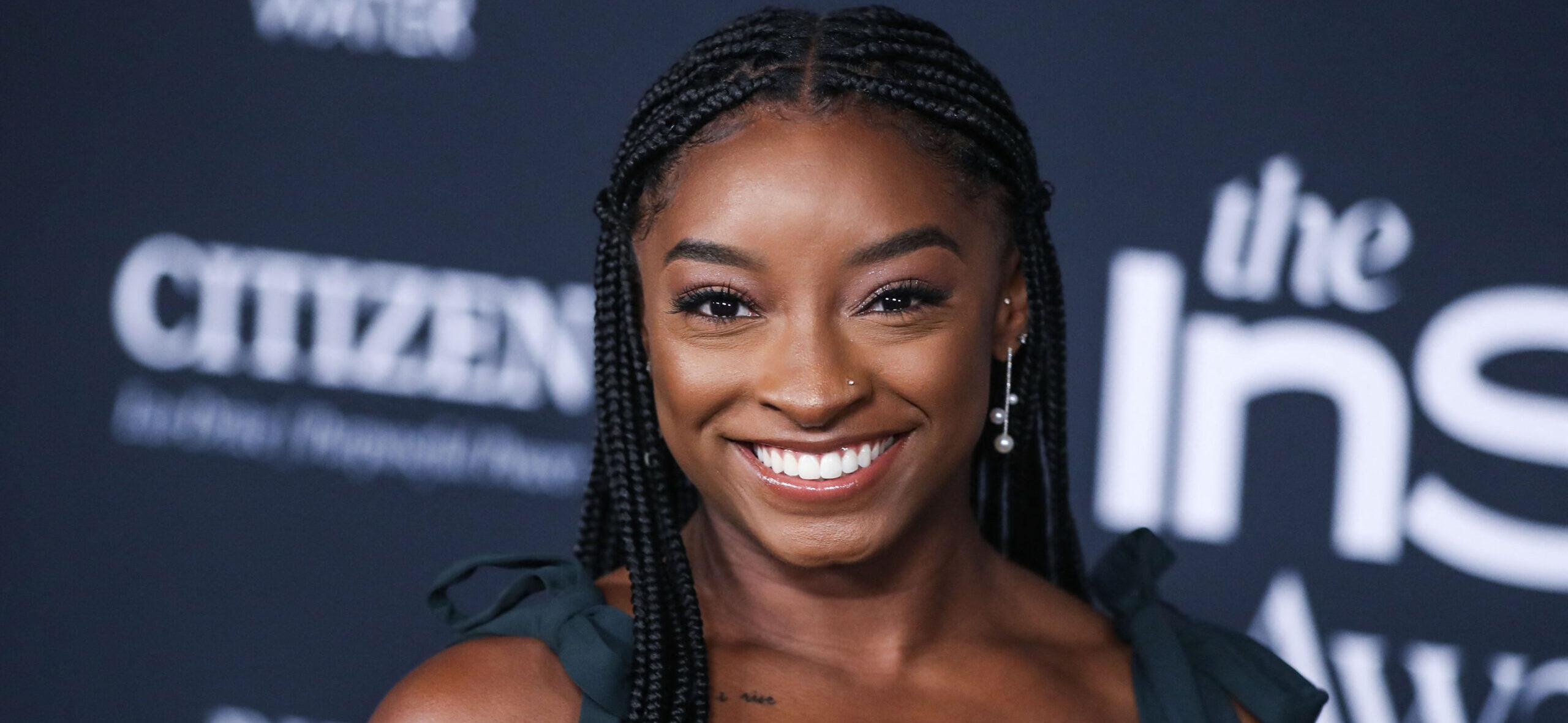 Simone Biles wearing an Aliette dress, Christian Louboutin shoes, and Matteo jewelry while carrying a Judith Leiber bag arrives at the 6th Annual InStyle Awards 2021