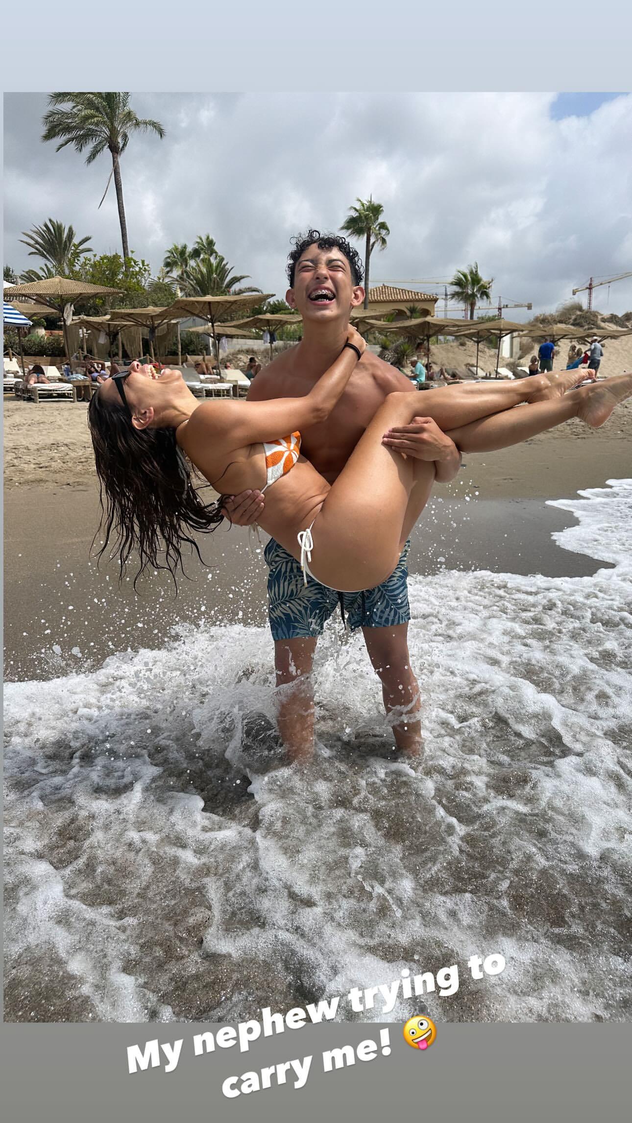 Eva Longoria being carried by her nephew.