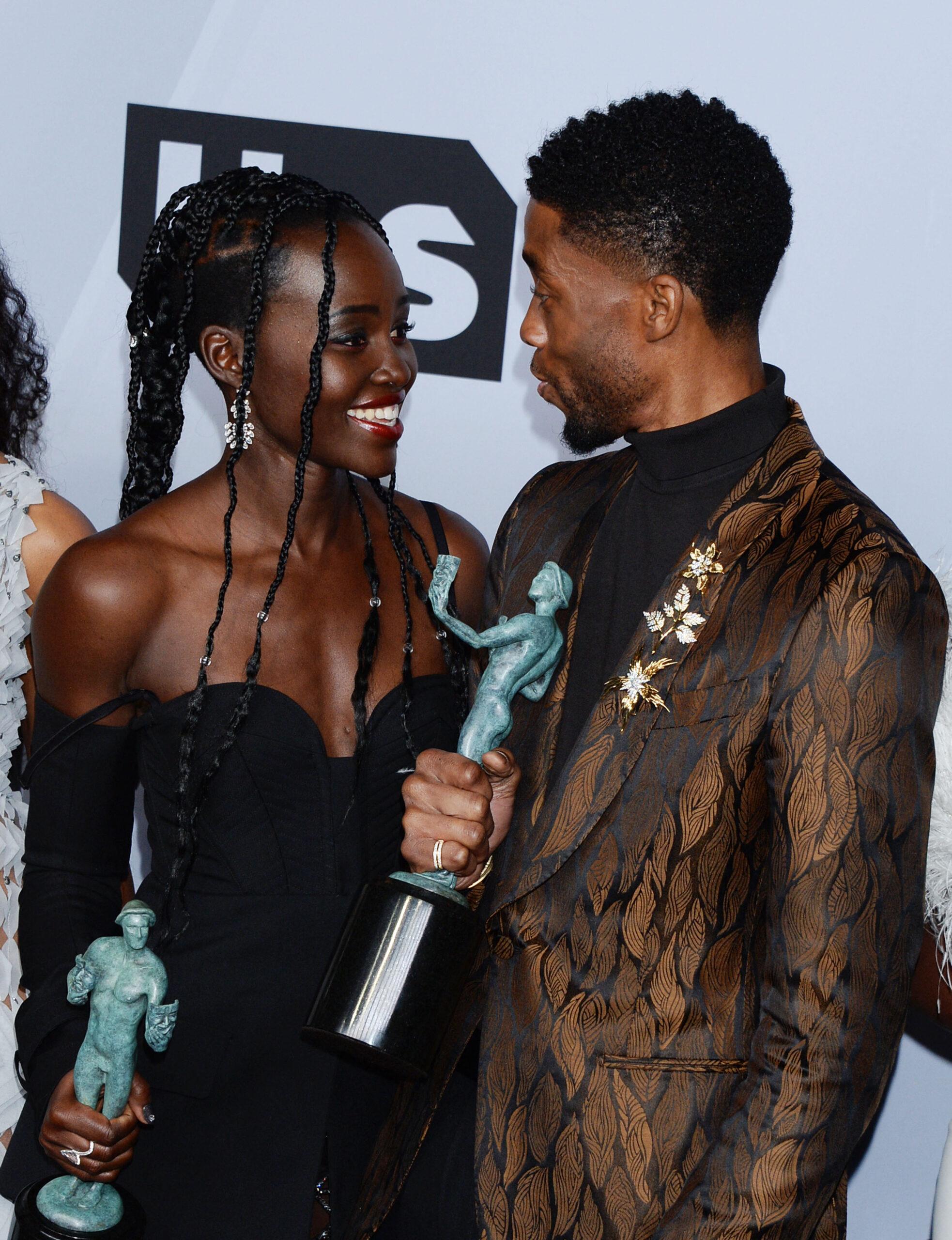 Lupita Nyong’o and Chadwick Boseman smiling