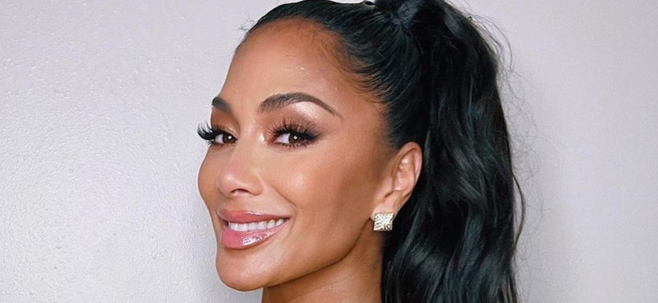 Nicole Scherzinger smiles at the camera.