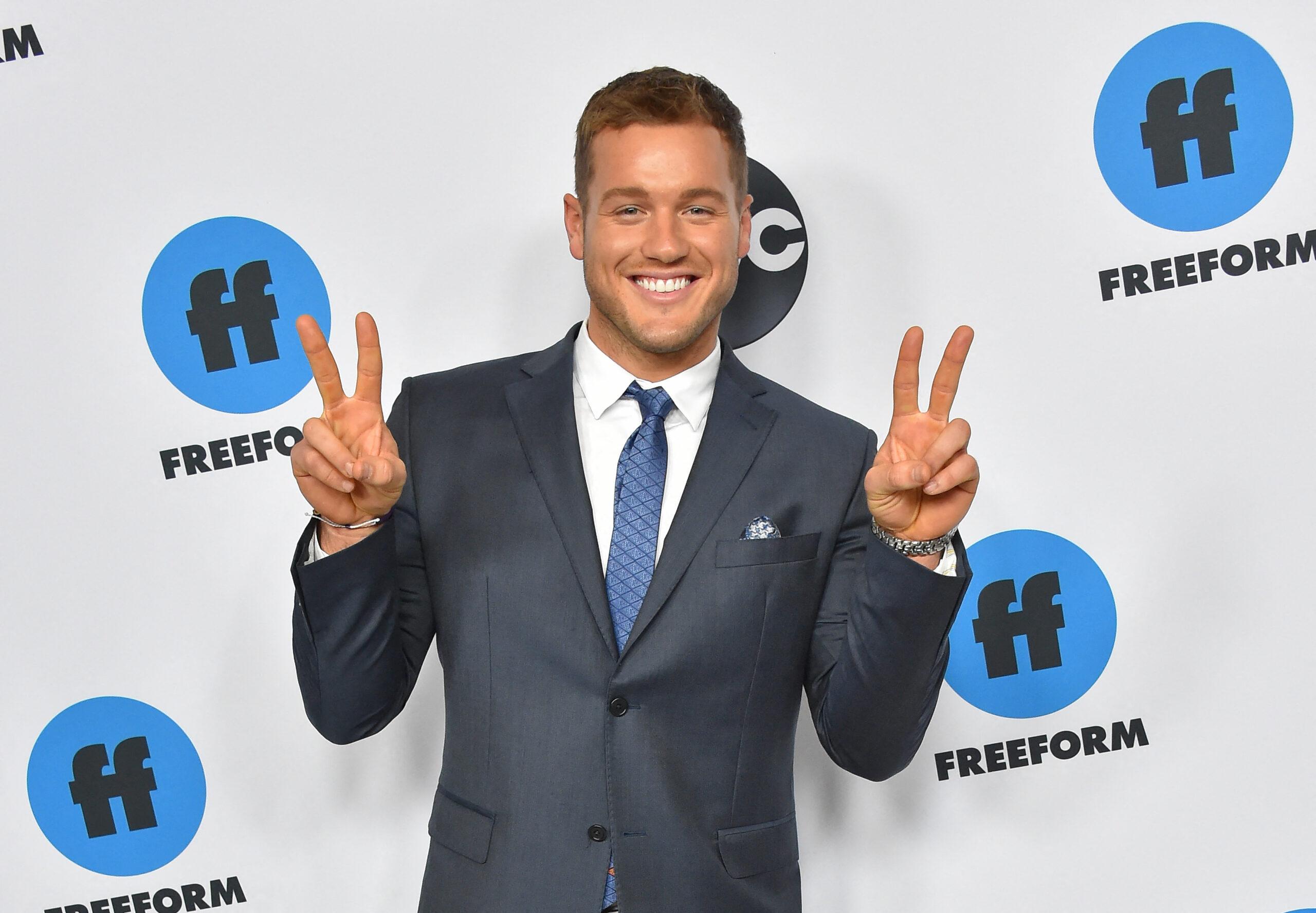 Colton Underwood gives peace signs