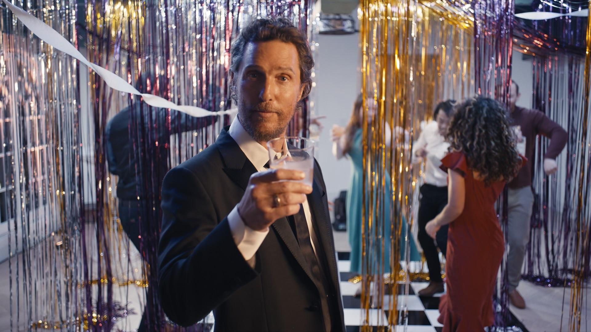 Matthew McConaughey holding a cocktail